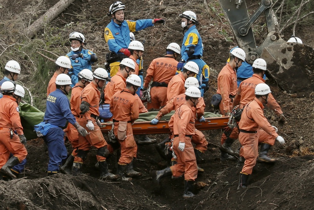 epa07004821 Tokyo Fire Department rescue workers carry a victim found at a large large landslide site in the Yoshino district of Atsuma, an area that was hit by a powerful earthquake, in Hokkaido, Japan, 08 September 2018. A 6.7 magnitude earthquake killed at least 20 people, leaving eight missing and injuring around 400 others, media reported. Eleven people are said to have suffered cardiopulmonary arrest. The quake hit the country’s northern island of Hokkaido in the early hours of 06 September, causing large landslides. Japanese Prime Minister Shinzo Abe ordered to dispatch 25,000 personnel of Japan's Self-Defense Forces (JSDF) to earthquake-hit areas. EPA/KIMIMASA MAYAMA
