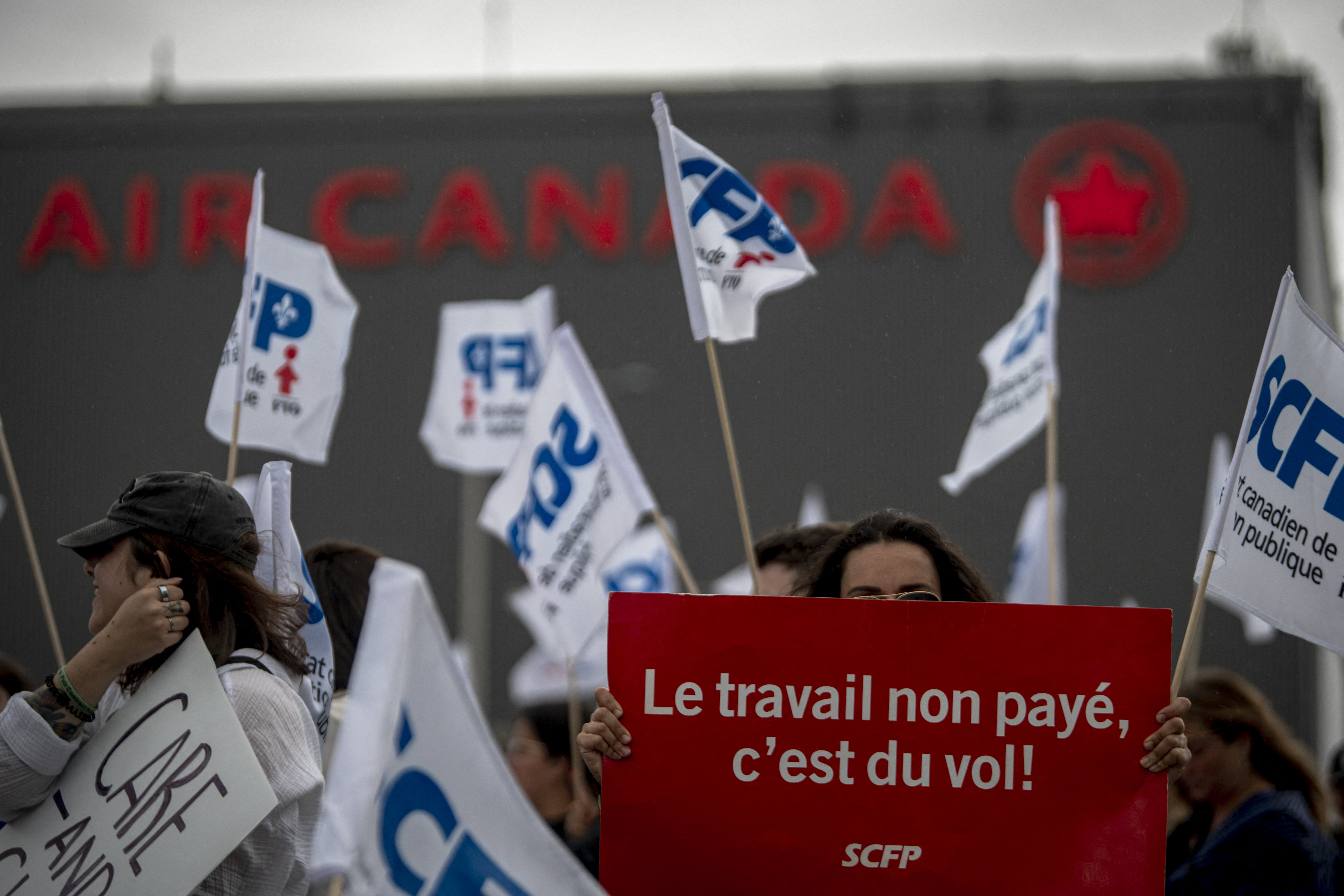 Flight attendants protest in front of the Air Canada headquarters near Pierre-Elliott Trudeau Airport in Montreal
