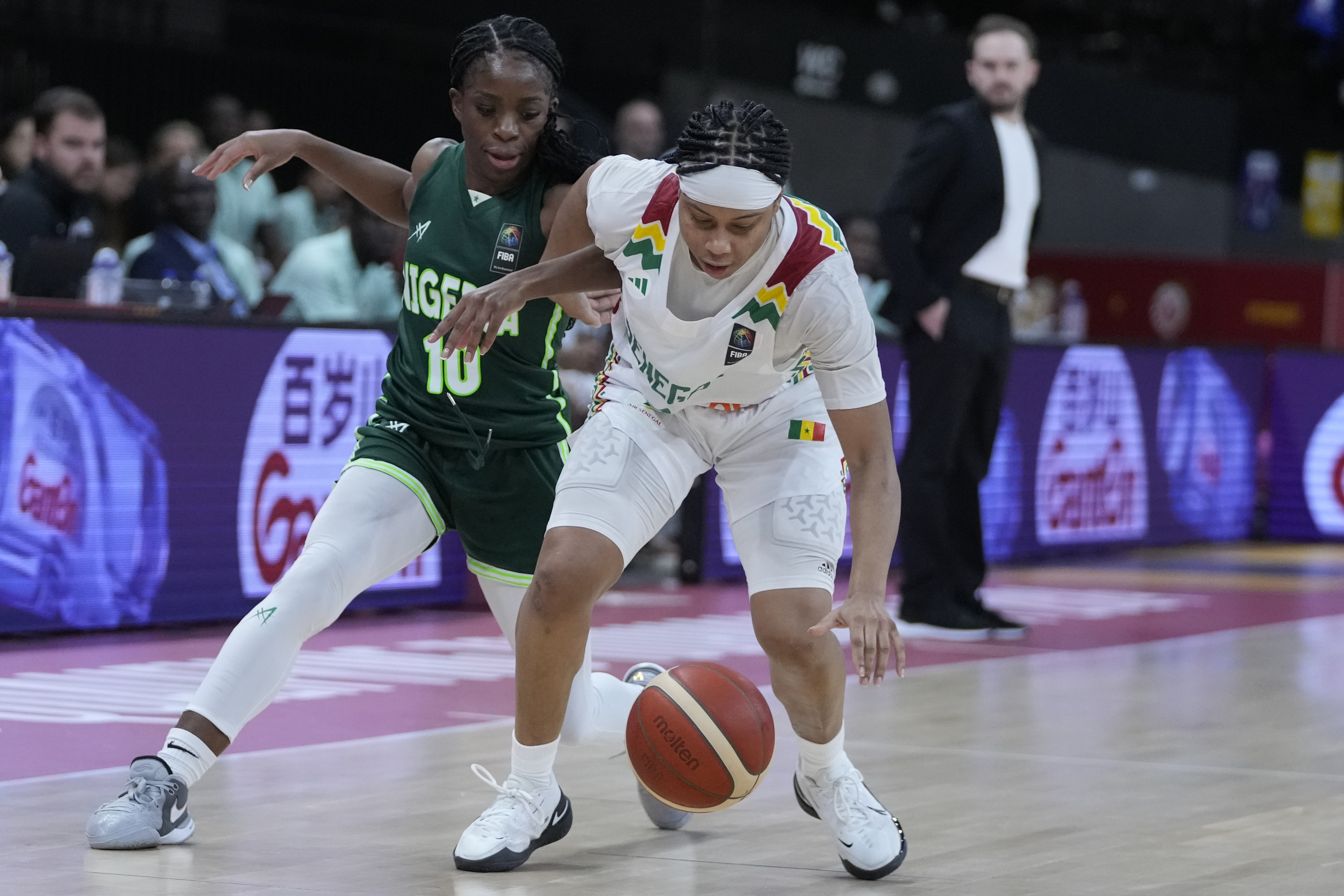 Senegal’s Cierra Dillard, right, and Nigeria’s Promise Amukamara chase a loose ball during a women’s Olympic qualifying group A match ahead of the Paris 2024 Games