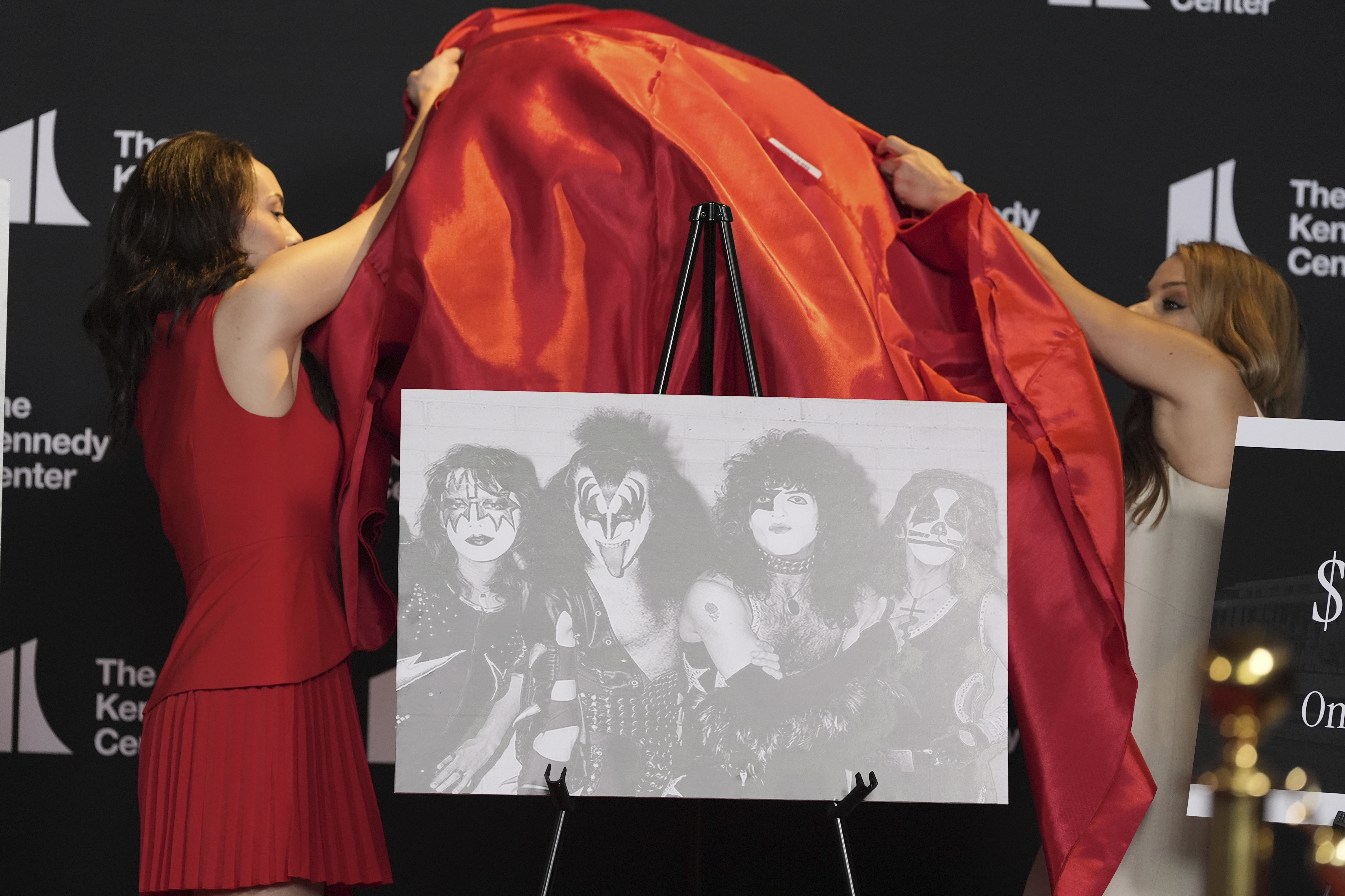 Presenters unveil a portrait of the rock group KISS at the Kennedy Center on August 13