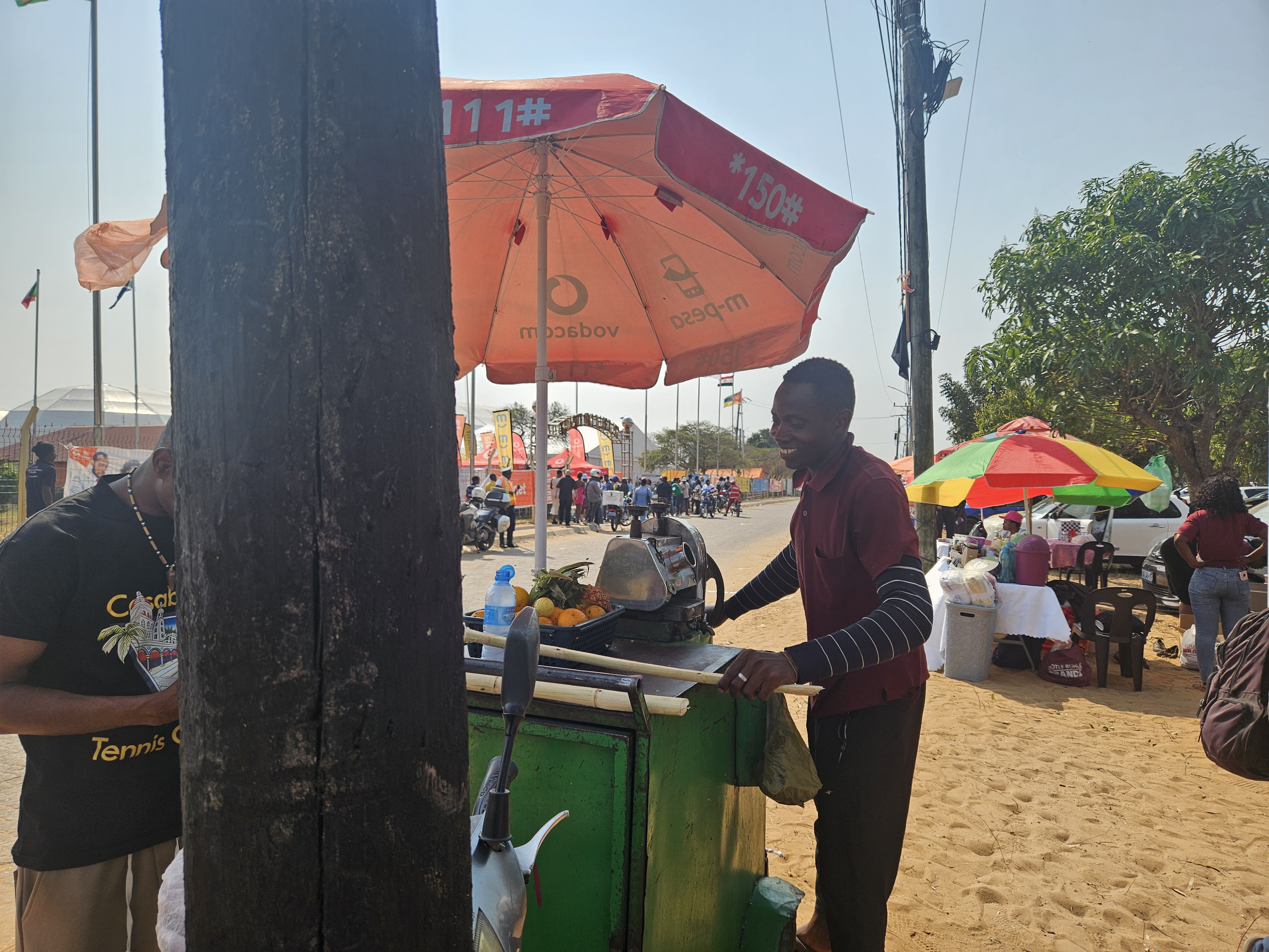 Informal vendors gather on the sandy pavements surrounding FACIM