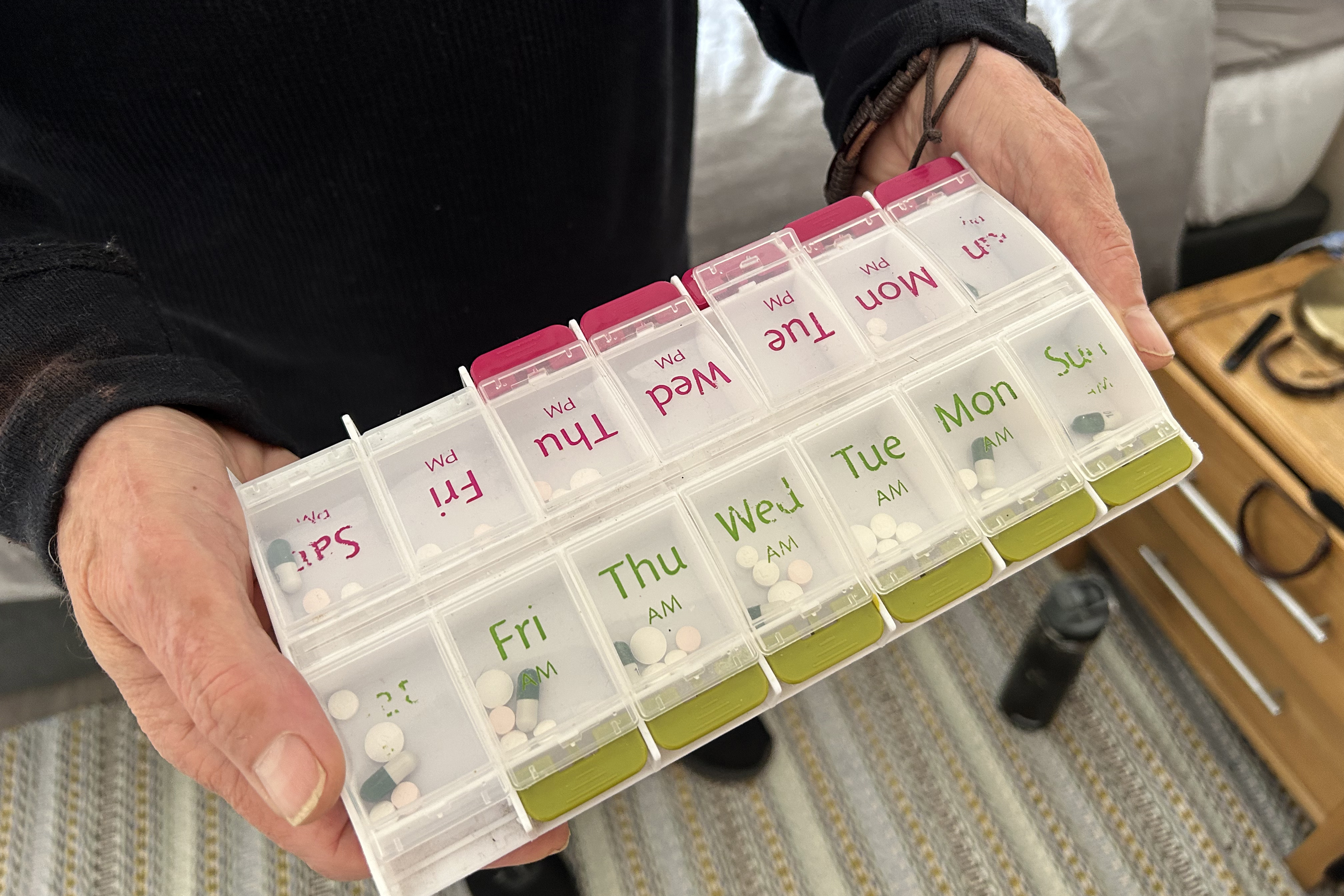 A pill box contains a week of Pandolfo’s medications