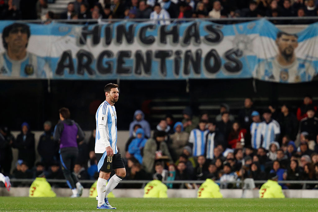Lionel Messi of Argentina stands in front of one of the many banners prepared for him by the home fans during the World Cup qualifier