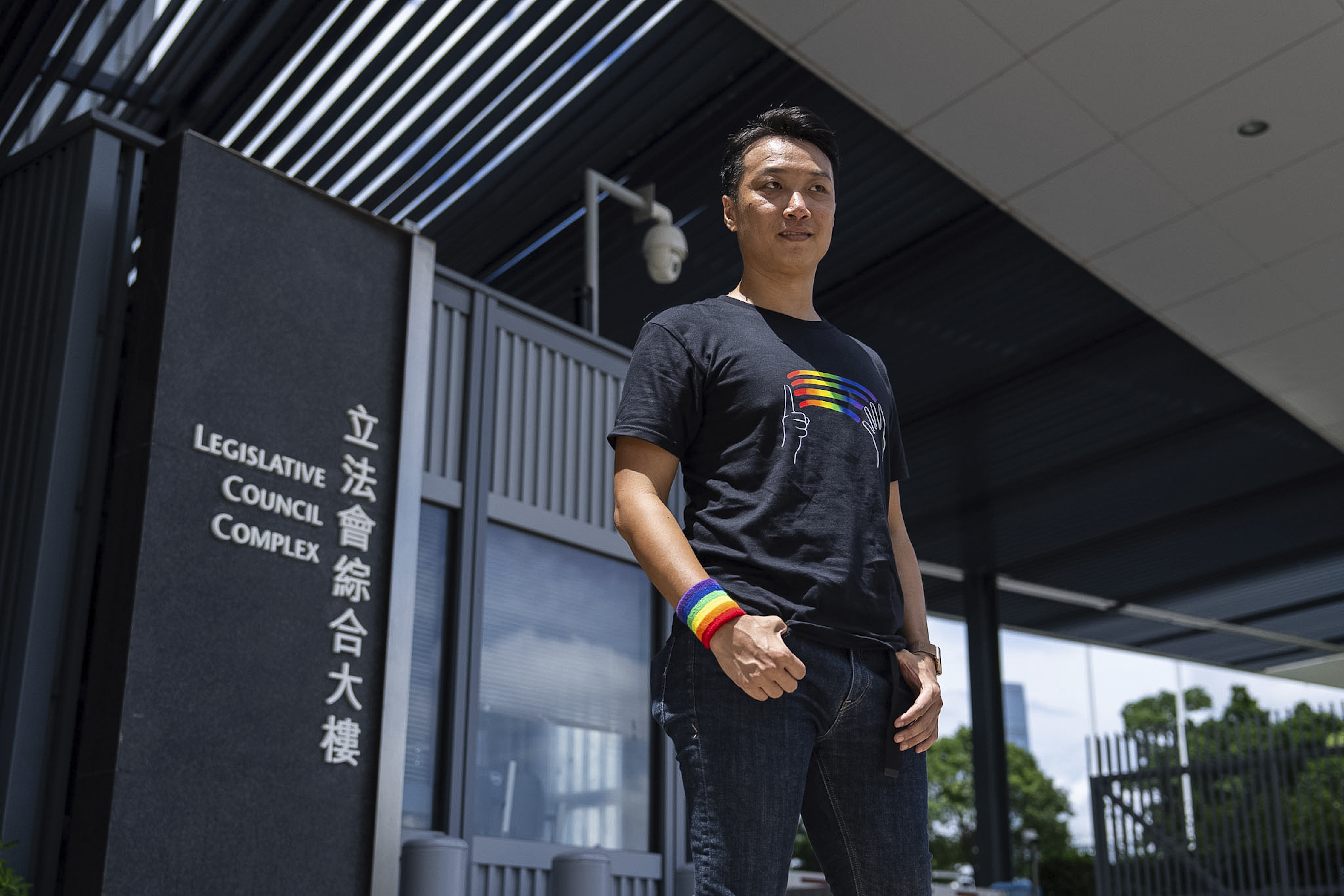 Jimmy Sham, gay rights activist poses for photographs in front of the Legislative Council before the legislative debate on a government bill recognizing same-sex partnerships, a proposed framework stemming from his successful legal challenge at the top court in Hong Kong, Wednesday, Sept. 10, 2025. (AP Photo/Chan Long Hei)