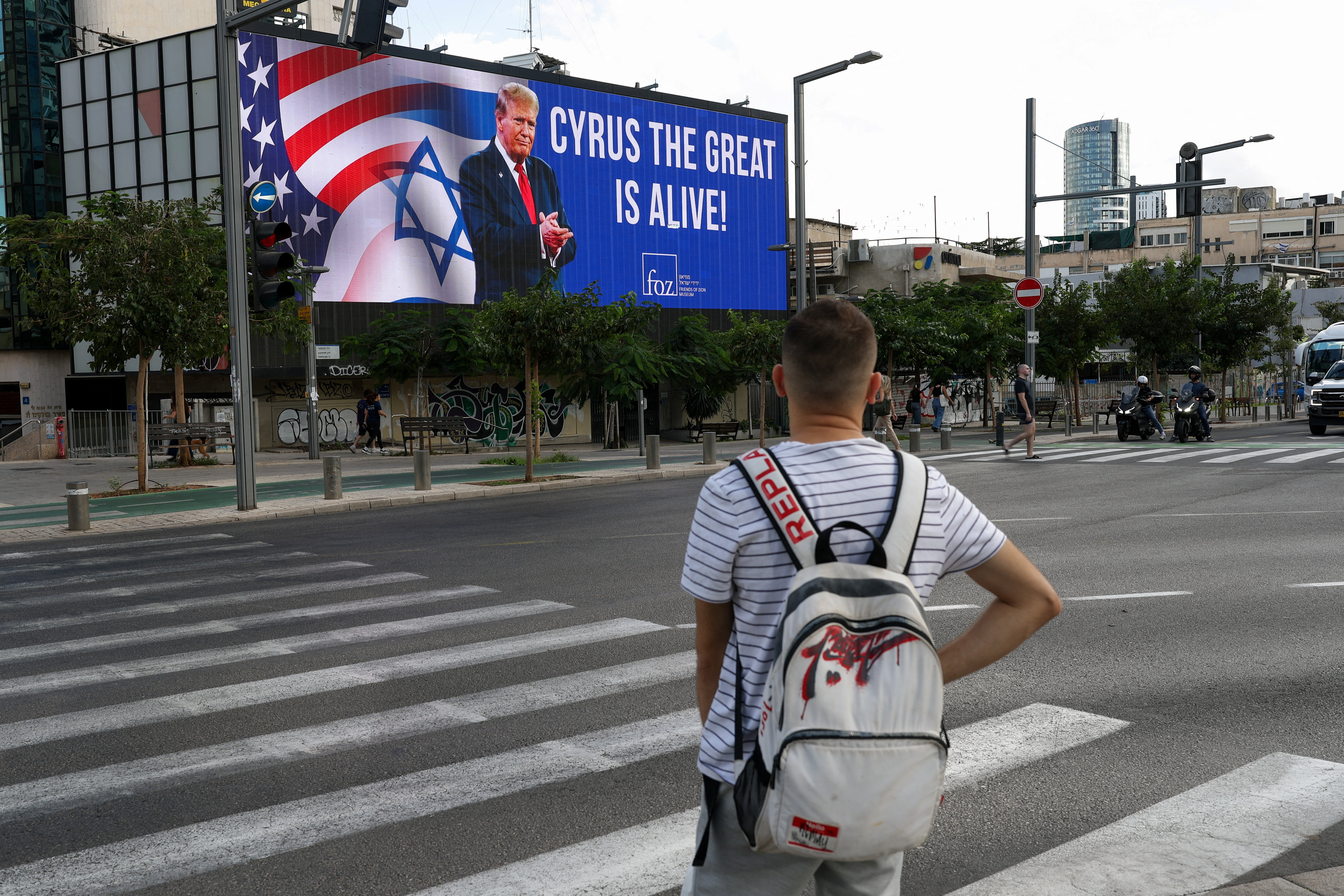 A billboard shows an image of U.S. President Donald Trump, amid a ceasefire between Israel and Hamas in Gaza, in Tel Aviv, Israel, October 12, 2025. REUTERS/Hannah McKay