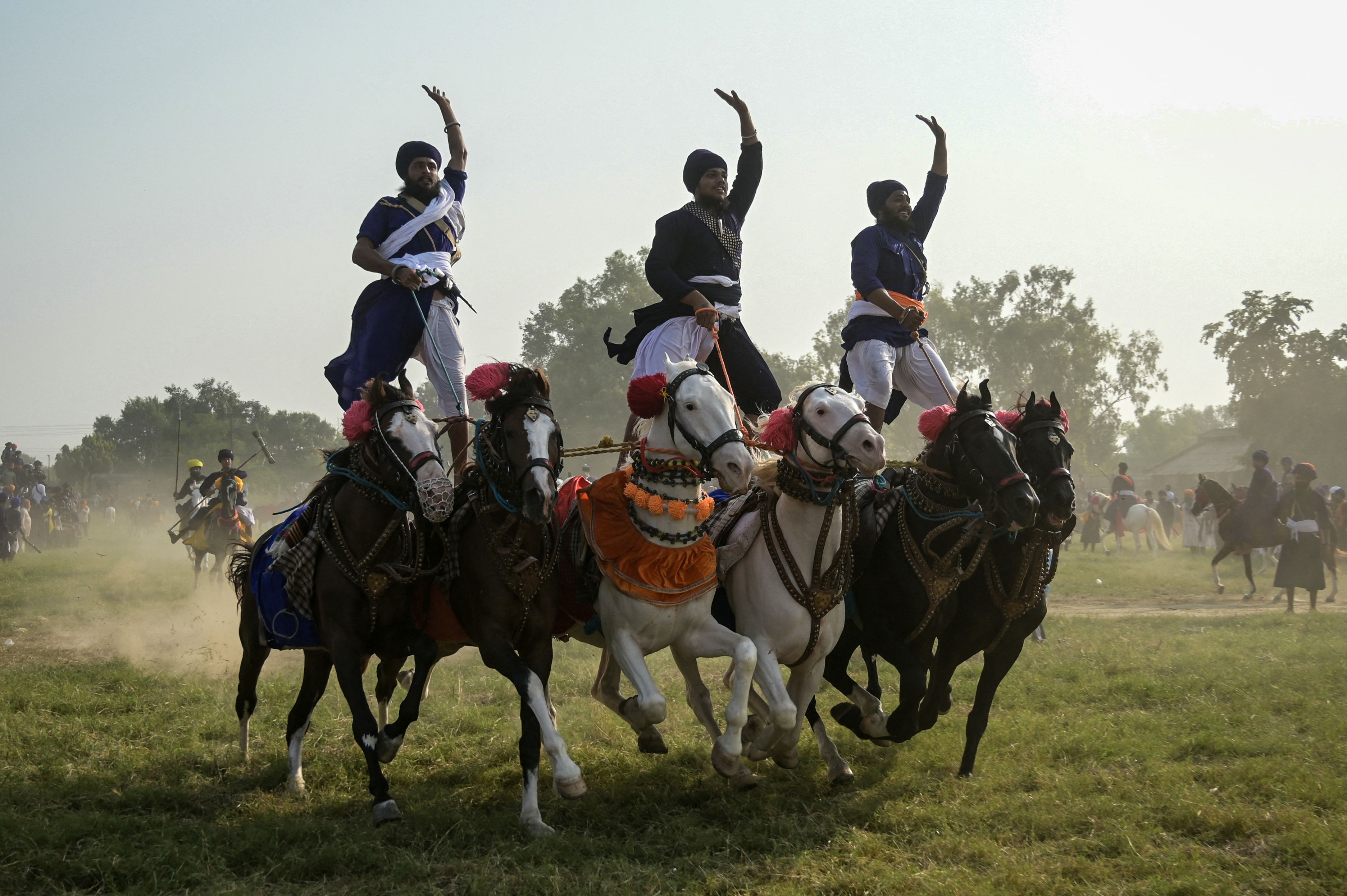 Nihang Sikh warriors ride on horses as they display their skills on the occasion of Fateh Divas in Amritsar