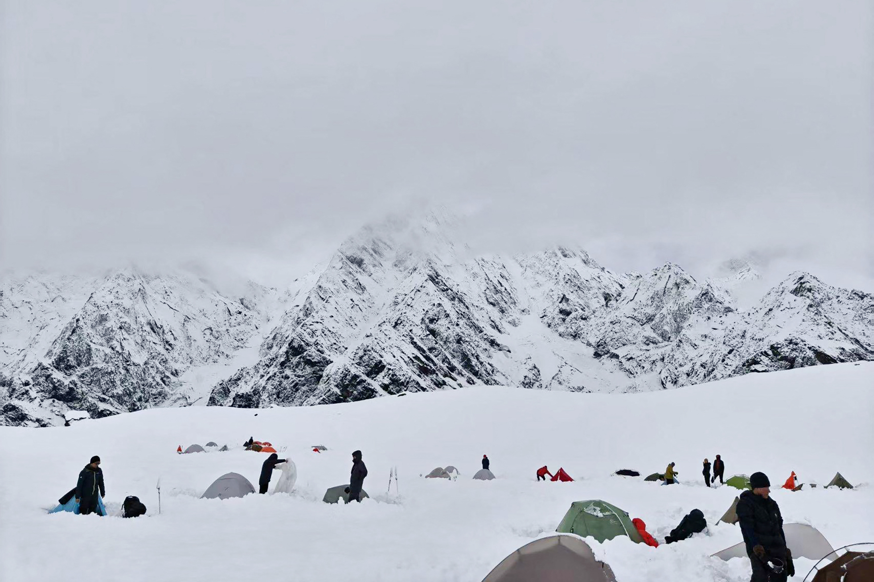 This handout image taken on October 5, 2025 and received on October 6 courtesy of FeiFei shows hikers amid deep snow at Tangxiang camp in the Karma Valley, at the foot of Everest in Tibet at an altitude of nearly 5,000 metres, following a sudden heavy snowfall in the region.