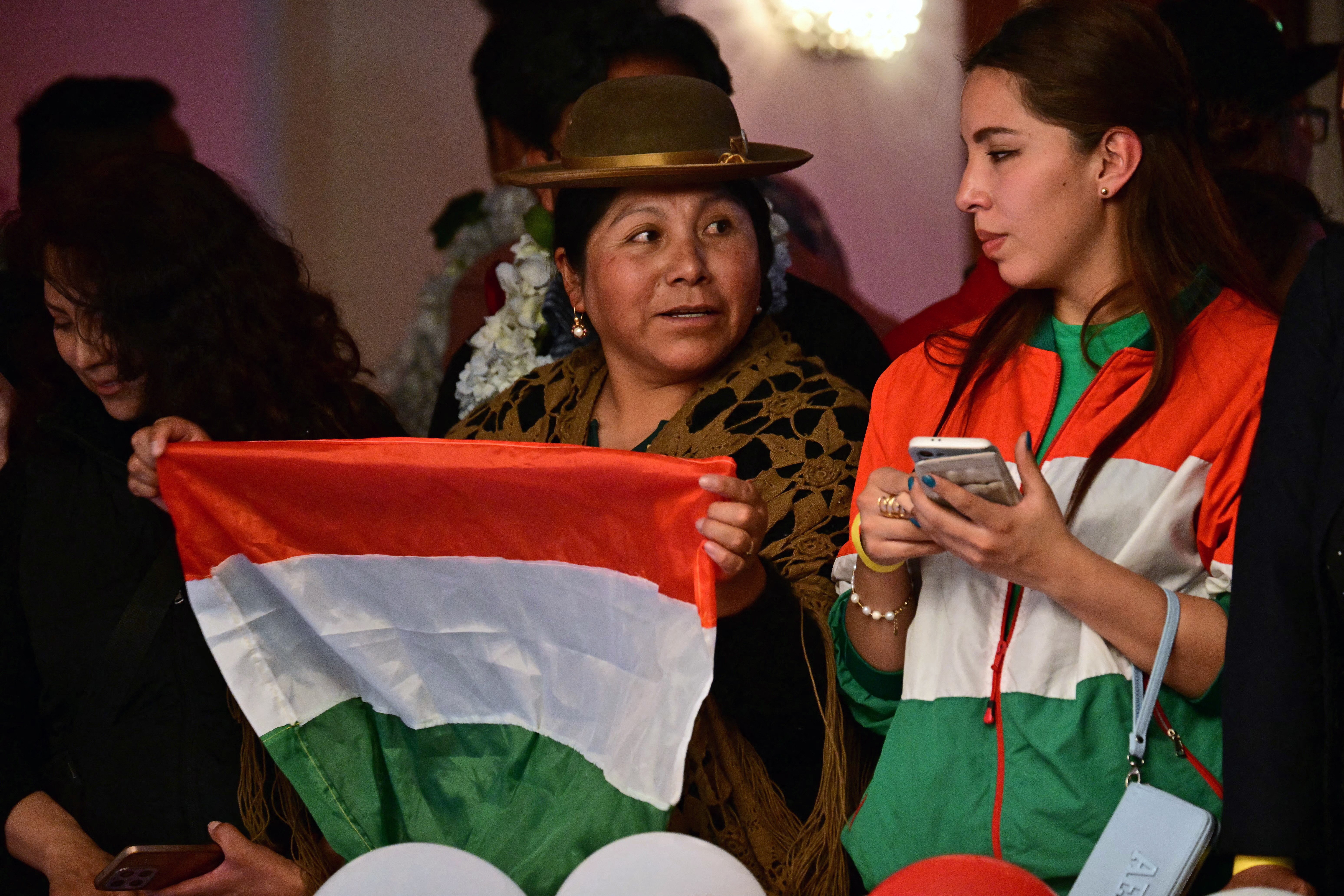 Supporters of Bolivia's presidential candidate for the Christian Democratic Party (PDC), Rodrigo Paz, celebrate after learning the results of the run-off presidential election in La Paz, on August 19, 2025.