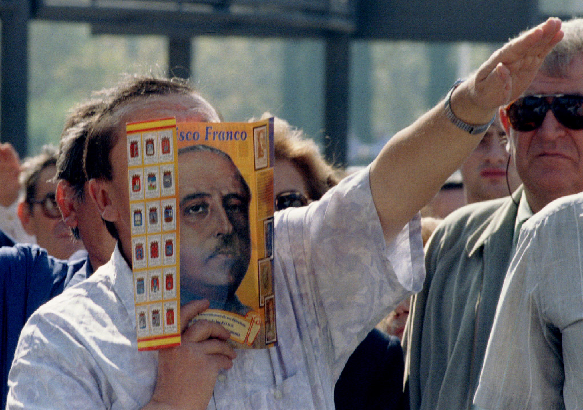 A right-wing extremist holds a mask of the late Spanish dictator General Franco over his face and gives the Nazi salute in during a fascist meeting in Barcelona October 12. Today is a national holiday in Spain, in celebration of the day Cristopher Columbus discovered America