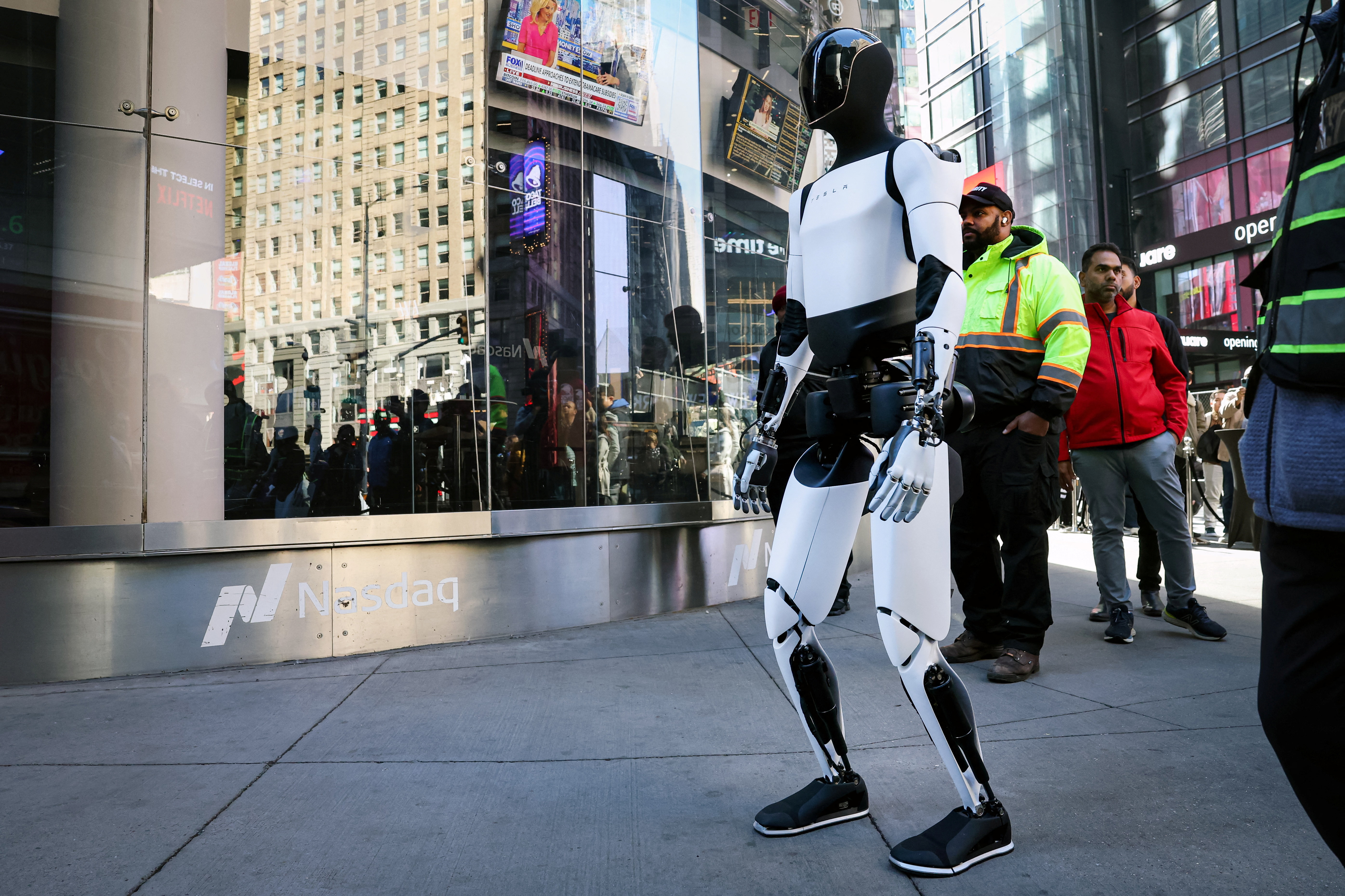 A Tesla Optimus robot walks during an appearance outside the Nasdaq Market site in New York City, US, on October 27, 2025