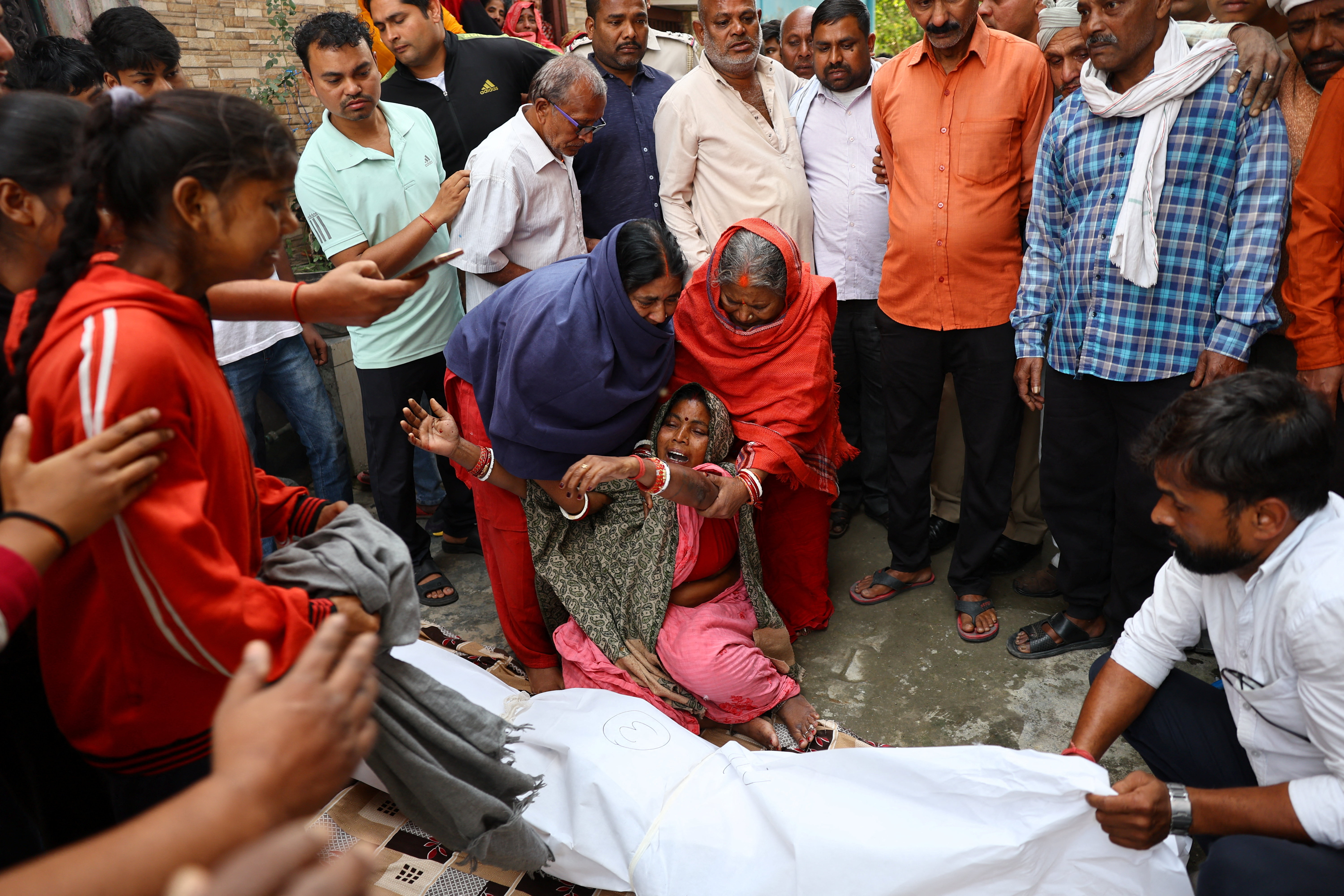 Gayatri Devi, mother of Pankaj Sahni, who died in a deadly explosion near the historic Red Fort in the old quarters of Delhi, reacts next to Sahni’s body outside his home before the funeral, in New Delhi, India, November 11, 2025