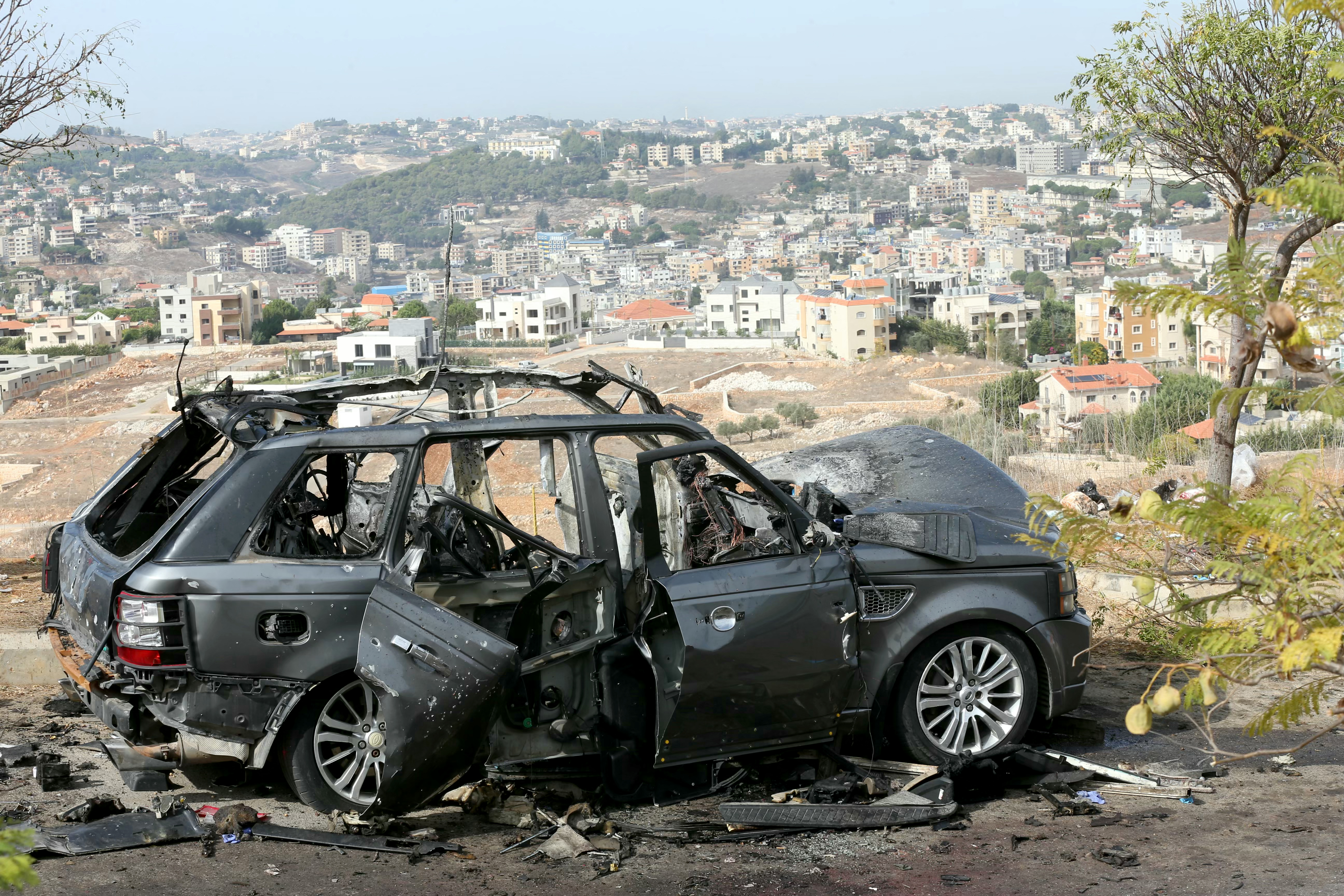 The wreckage of a vehicle is left strewn on the side of the road, a day after an Israeli air strike that killed its occupants, in the southern Lebanese village of Kfar Roummane