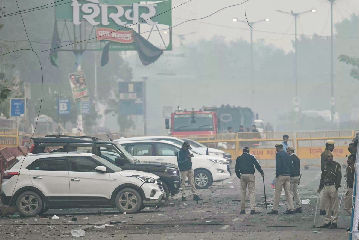 Security personnel check for evidence at the blast site following an explosion near the Red Fort in the old quarters of Delhi on November 11, 2025