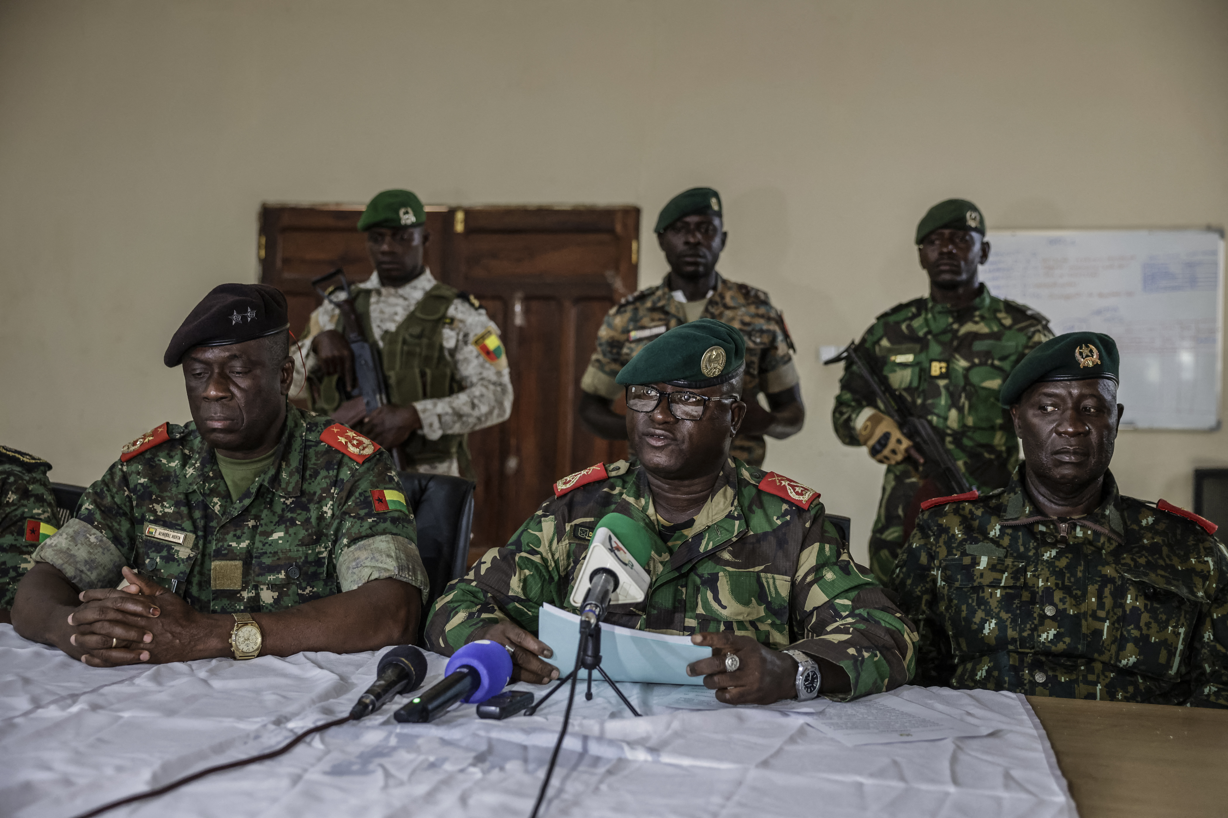 Brigadier General Denis N'Canha (C), head of the military office of the presidency, addresses the media