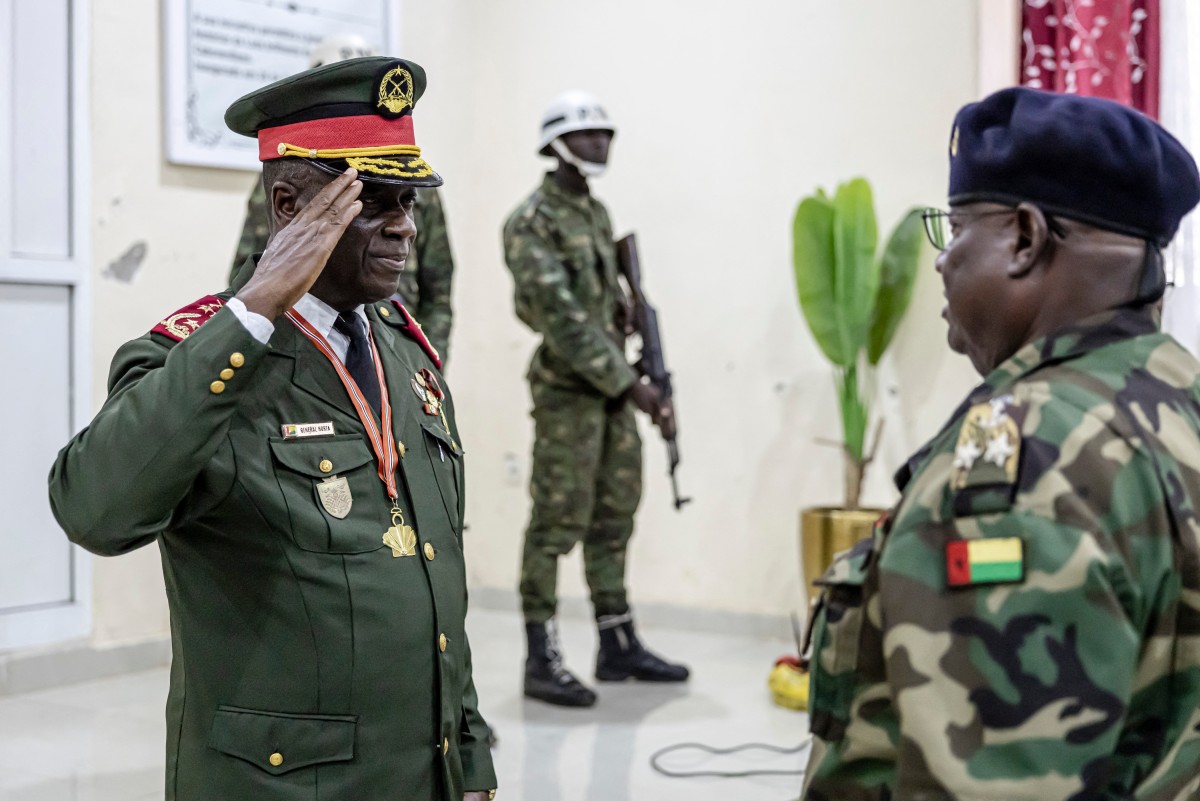 Guinea Bissau Army general Horta N'Tam (L) salutes an officer during the swearing in ceremony as the transition leader and the leader of the High Command in Bissau on November 27, 2025. The Guinea-Bissau military appointed a general as the country's new leader Thursday for one year, a day after seizing power and arresting the president of the coup-prone west African nation. "I have just been sworn in to lead the High Command," General Horta N'Tam declared after taking the oath of office in a ceremony at the military's headquarters, AFP journalists observed. Dozens of heavily armed soldiers were deployed at the scene.