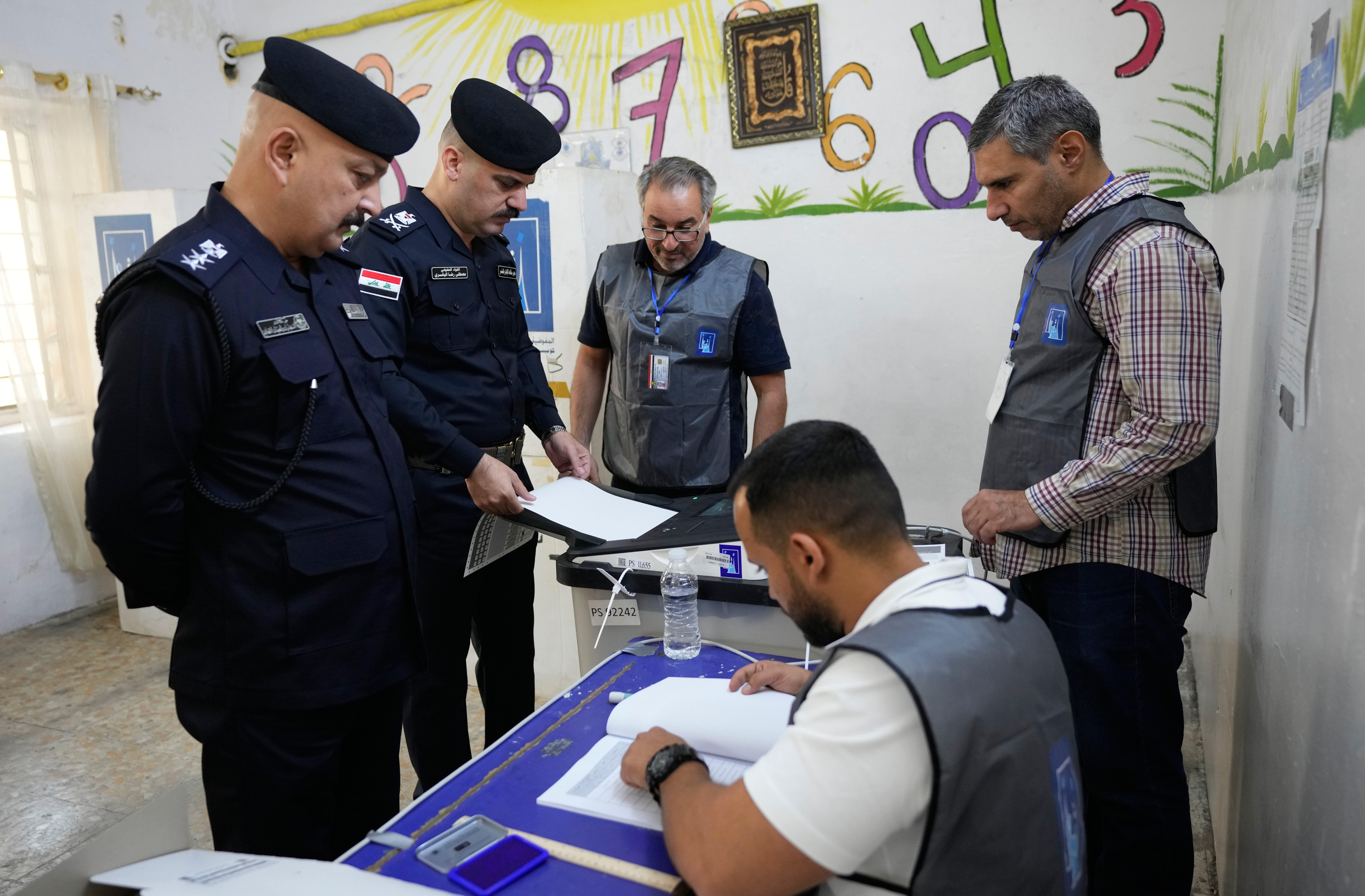 Iraqi policemen gather to vote.