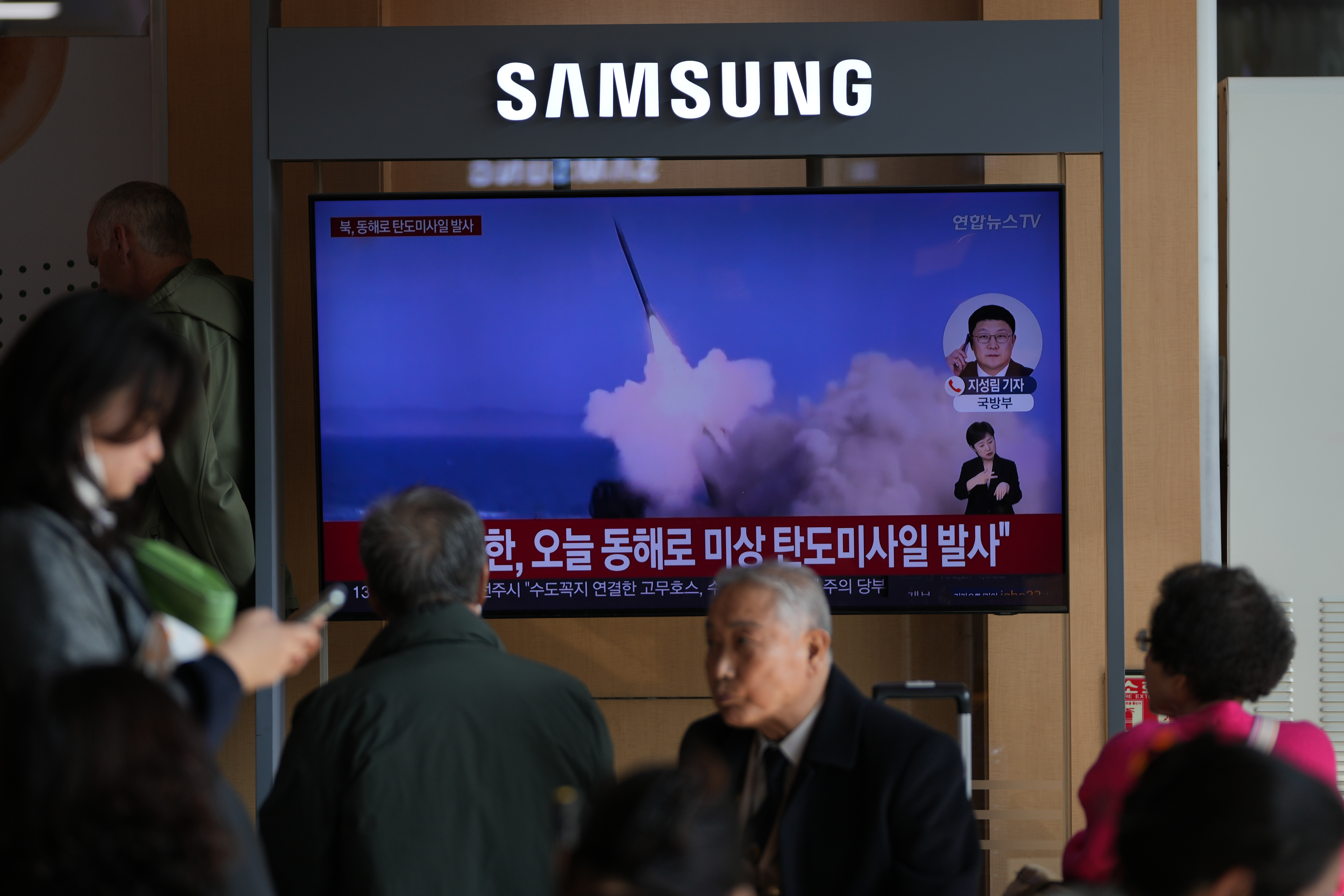 A TV screen shows a North Korean missile launch at the Seoul Railway Station in Seoul, South Korea, on Friday