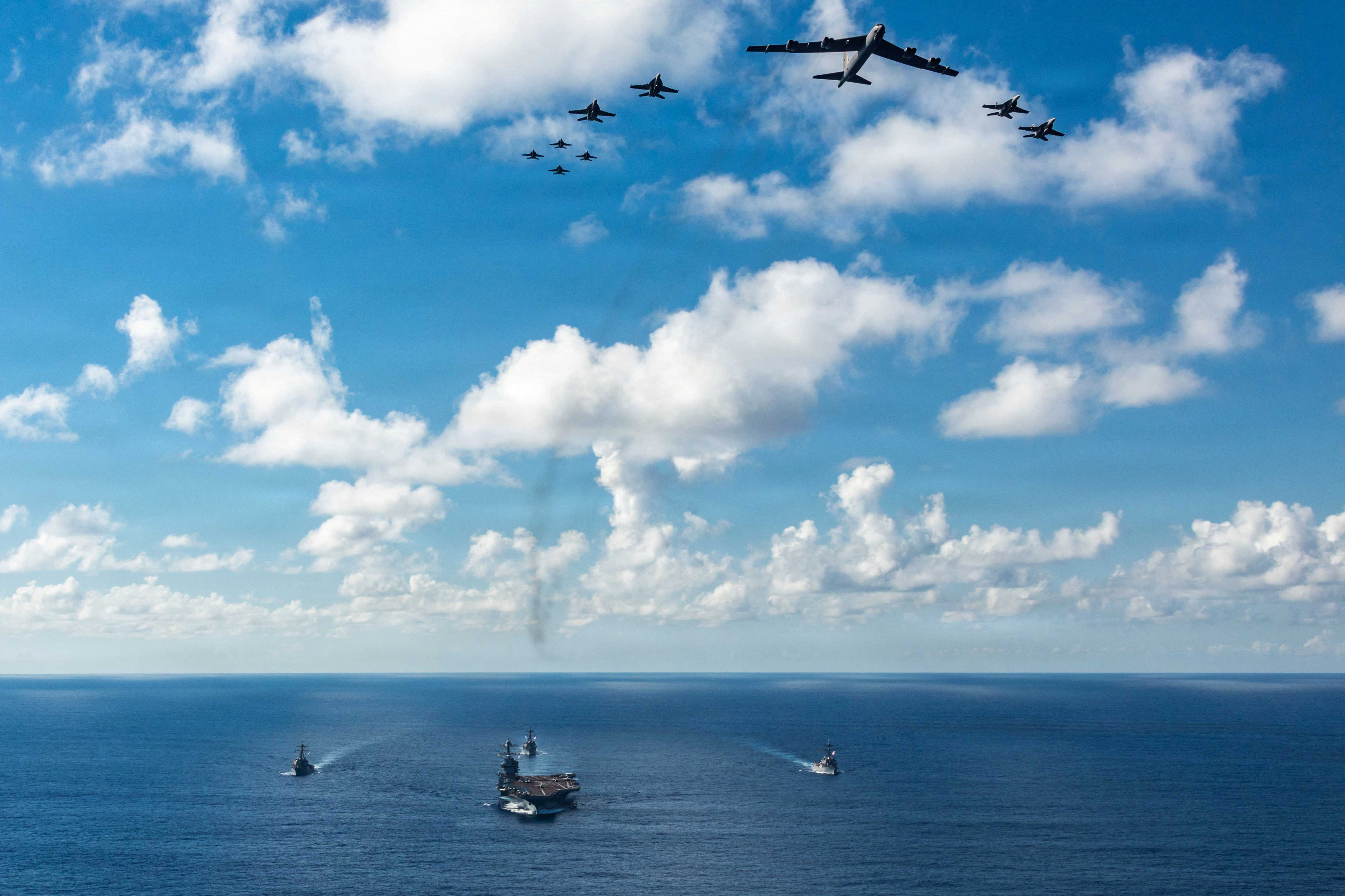 The U.S. Navy’s Gerald R. Ford Carrier Strike Group, including the flagship USS Gerald R. Ford, USS Winston S. Churchill, USS Mahan and USS Bainbridge, sail towards the Caribbean Sea under F/A-18E/F Super Hornets and a U.S. Air Force B-52 Stratofortress, in the Atlantic Ocean November 13, 2025. U.S. Navy/Petty Officer 3rd Class Gladjimi Balisage/Handout via REUTERS. THIS IMAGE HAS BEEN SUPPLIED BY A THIRD PARTY