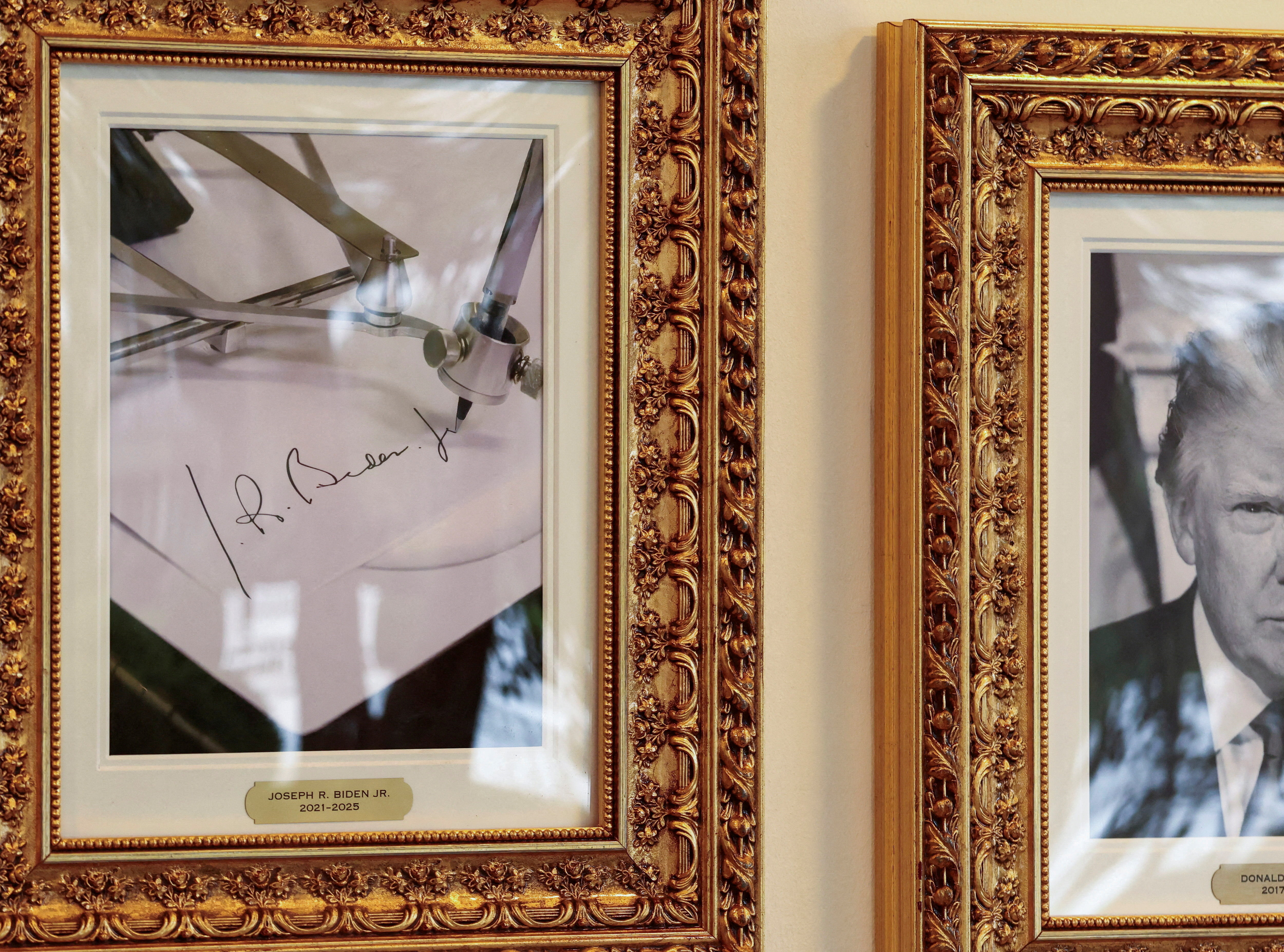 An image of an autopen writing former US President Joe Biden's signature is displayed next to a portrait of US President Donald Trump at the Presidential Walk of Fame in the White House in Washington, DC, on September 25, 2025 [Kevin Lamarque/Reuters]