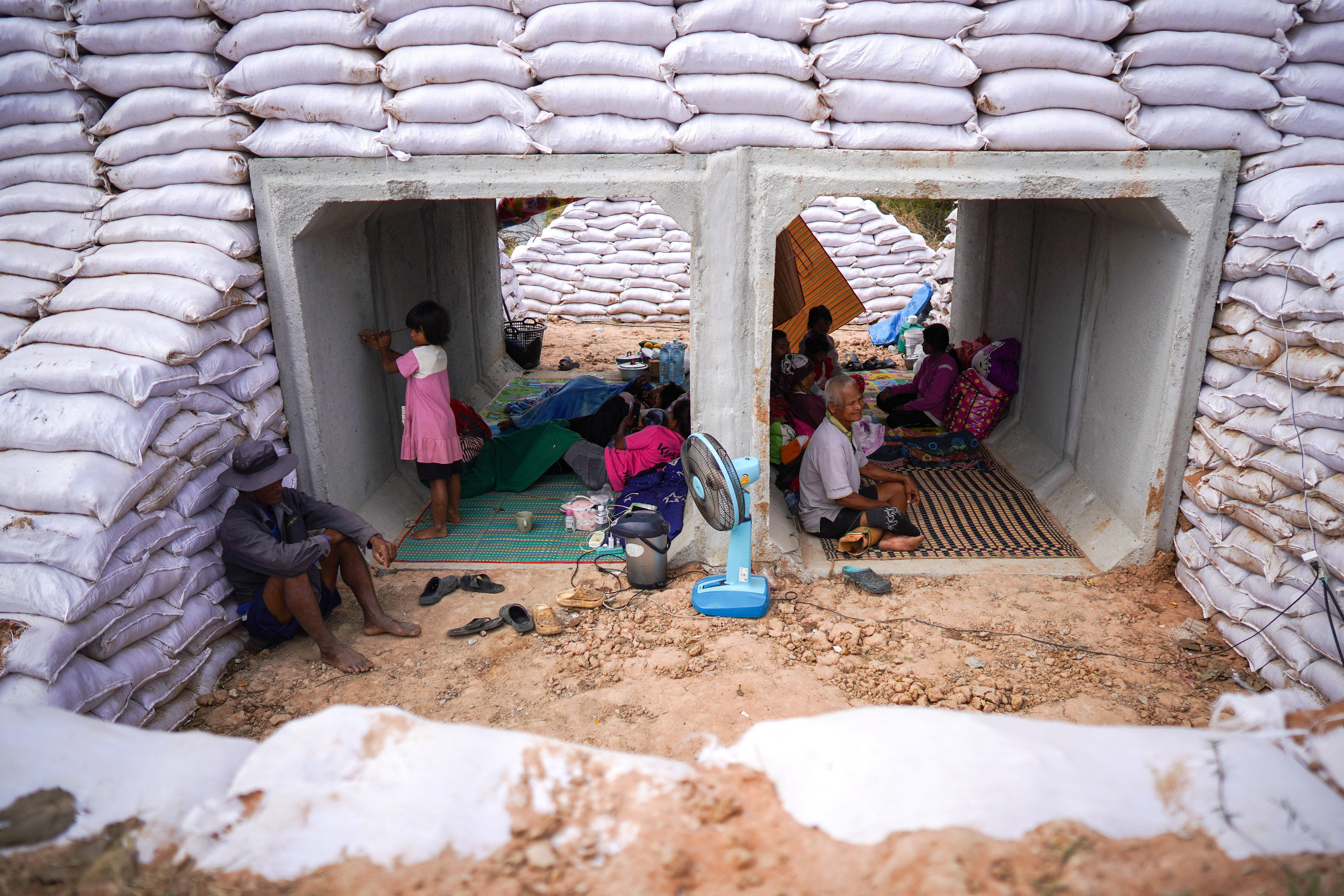 People take shelter inside a bunker amid deadly clashes between Thailand and Cambodia along a disputed border area in Sa Kaeo province, Thailand, December 10, 2025. REUTERS/Athit Perawongmetha