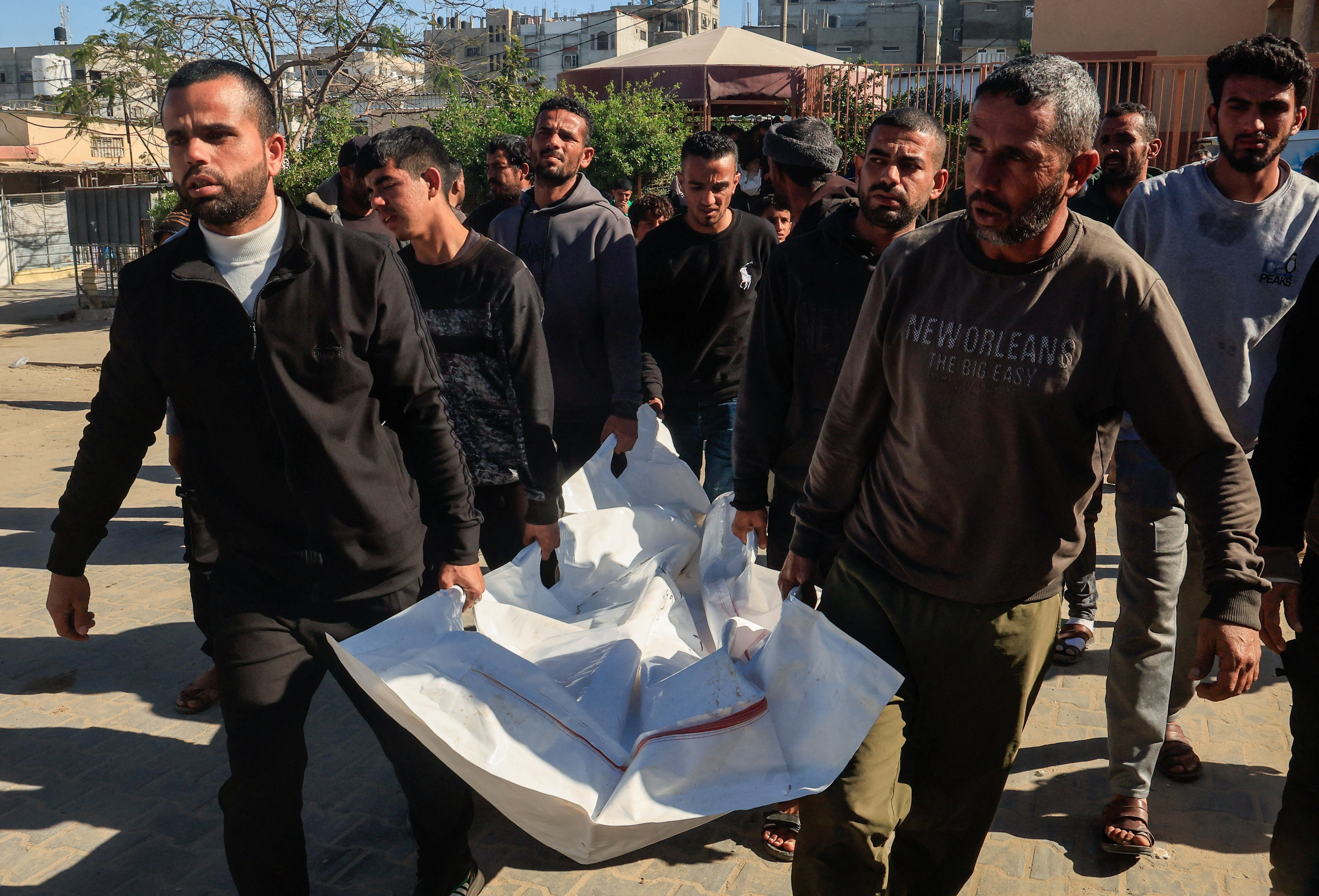 People carry a body during the funeral of Palestinians who, according to medics, were killed in an Israeli strike on Sunday,