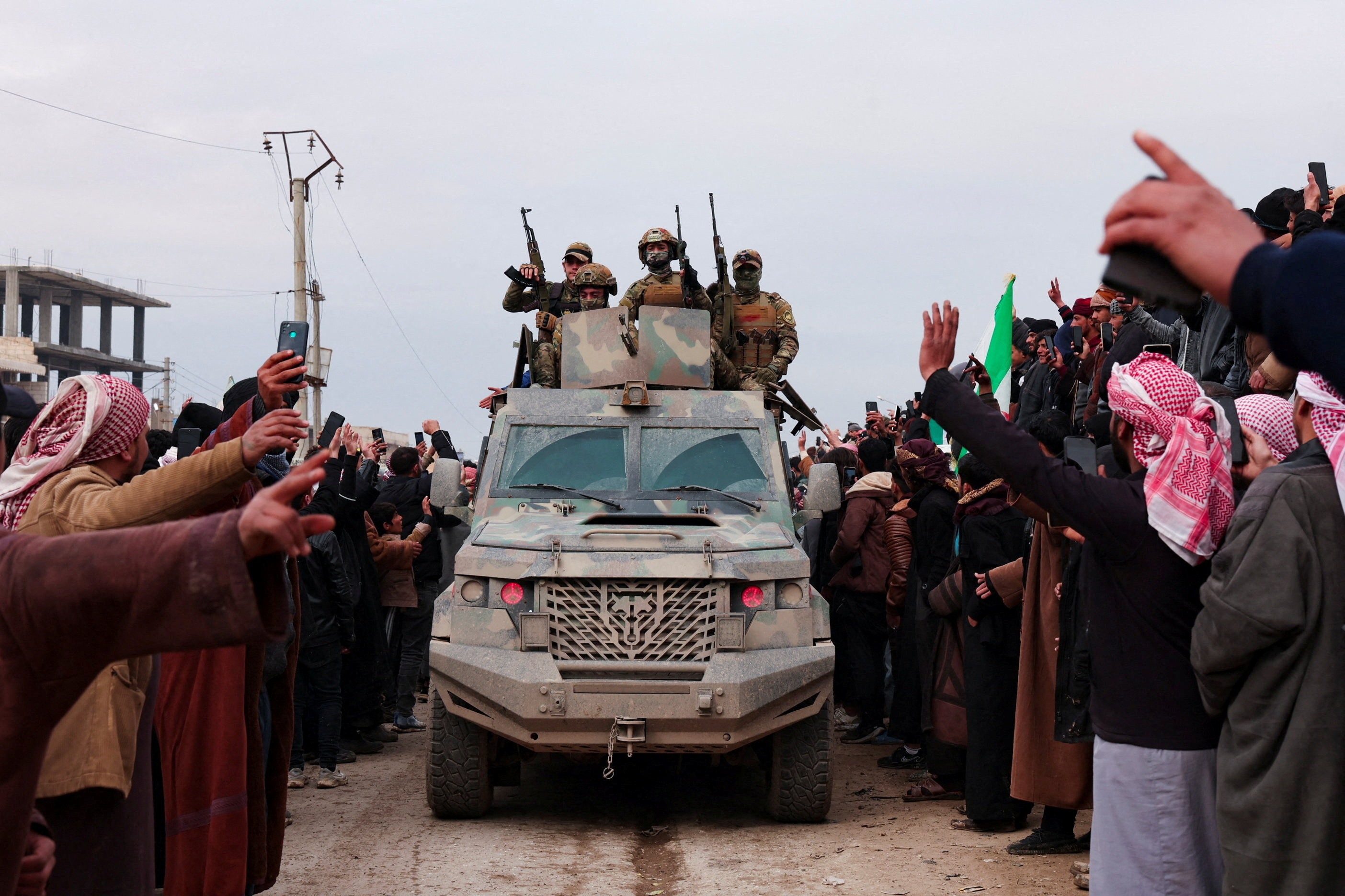 People welcome Syrian army following the withdrawal of the Kurdish-led Syrian Democratic Forces (SDF) in Maskanah, Syria