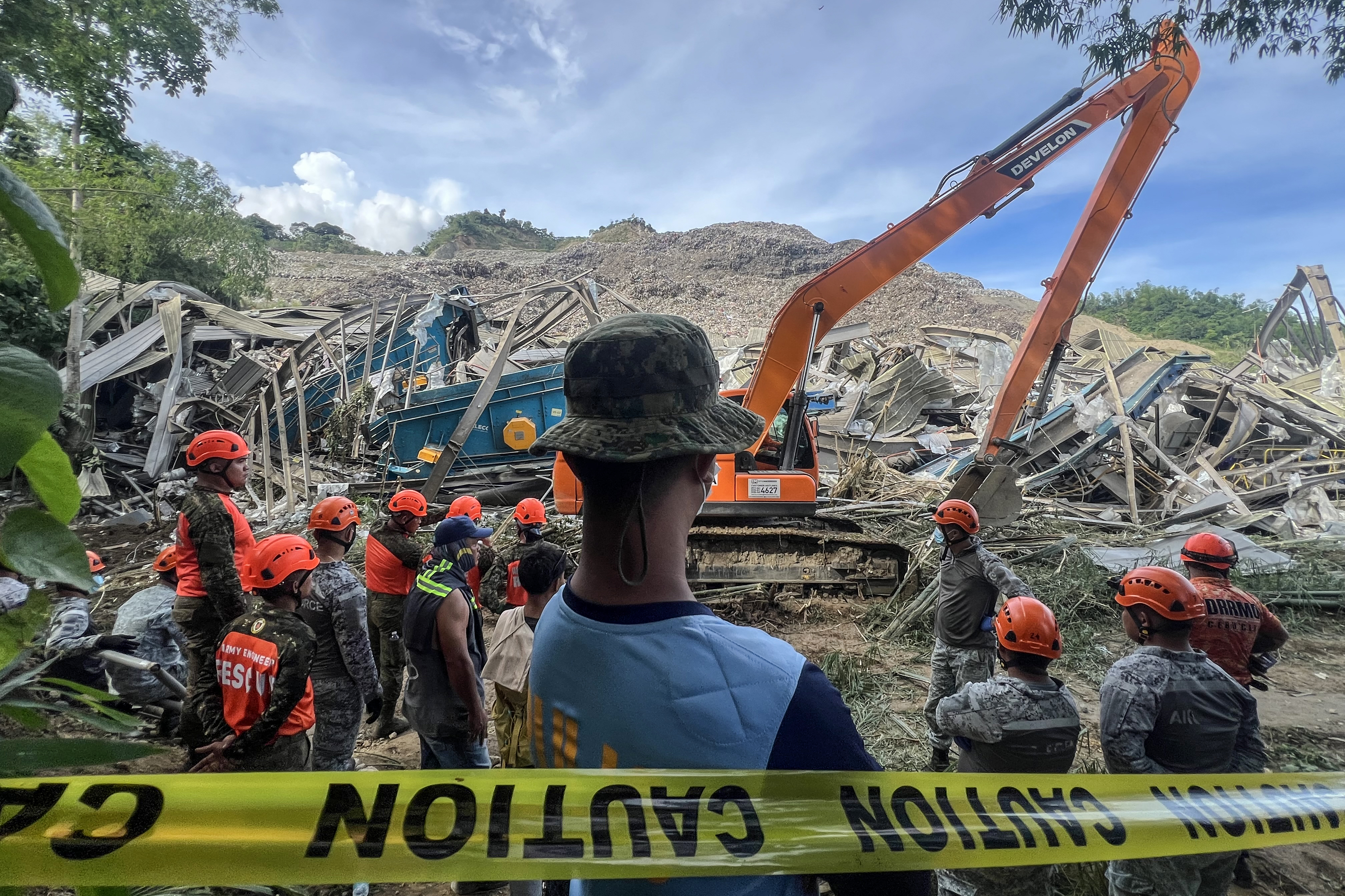 Search and rescue teams look for people after a landslide at the landfill in Barangay Binaliw, Cebu City