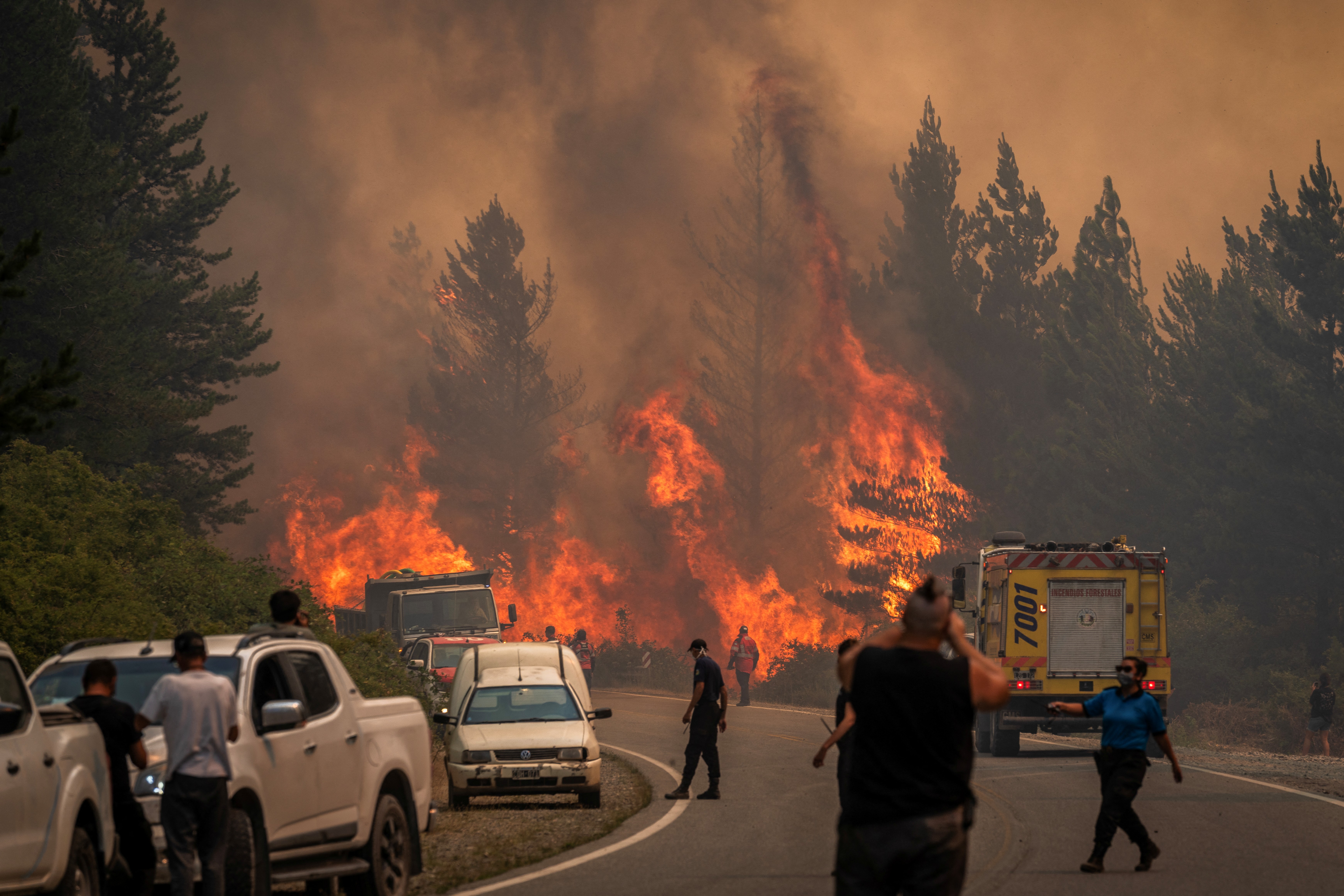 Firefighters battle the flames to extinguish a bushfire in Mount Pirque at El Hoyo, in the Patagonian region of Chubut province, Argentina