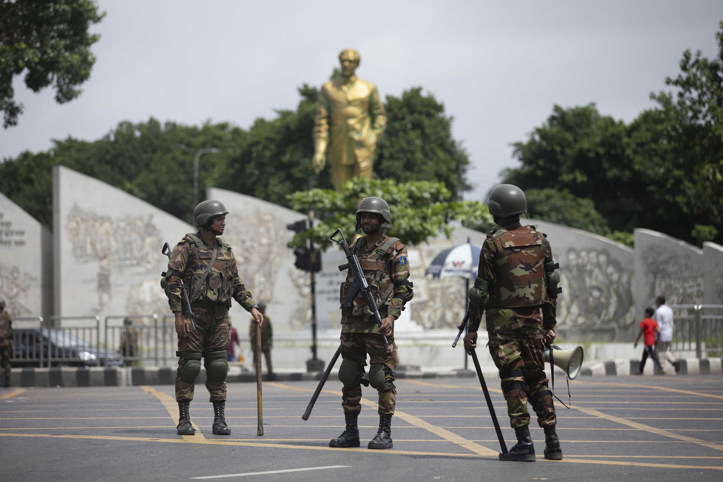 Bangladeshi military forces soldiers patrol on a street in Dhaka, Bangladesh, Saturday, July 20, 2024. Bangladeshi authorities extended a curfew across the country on Sunday as the nation's top court was expected to rule on a civil service hiring quota that has led to days of deadly clashes between police and protesters, killing scores of people.(AP Photo/Rajib Dhar)