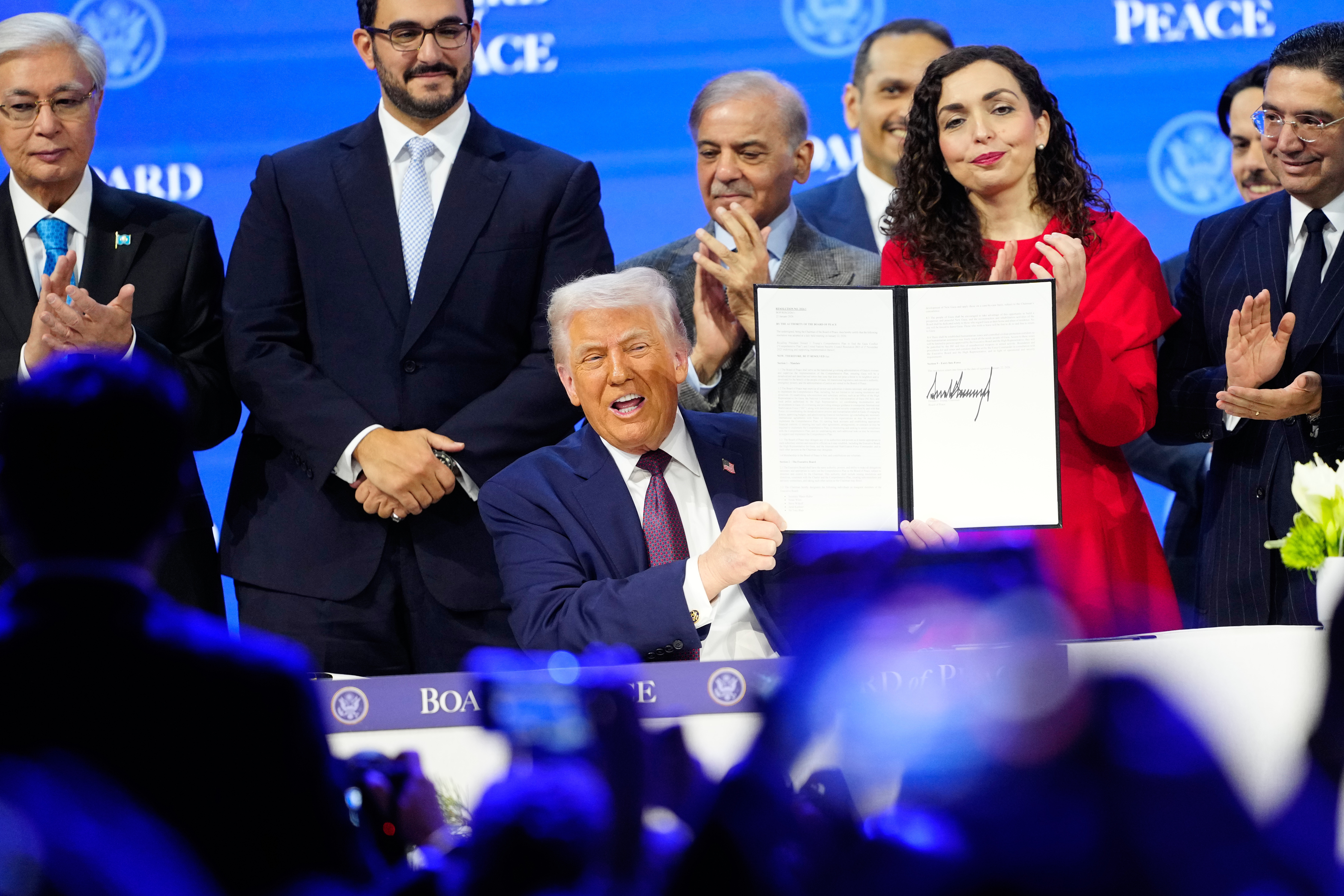 President Donald Trump holds the charter during a signing ceremony on his Board of Peace initiative at the Annual Meeting of the World Economic Forum in Davos, Switzerland