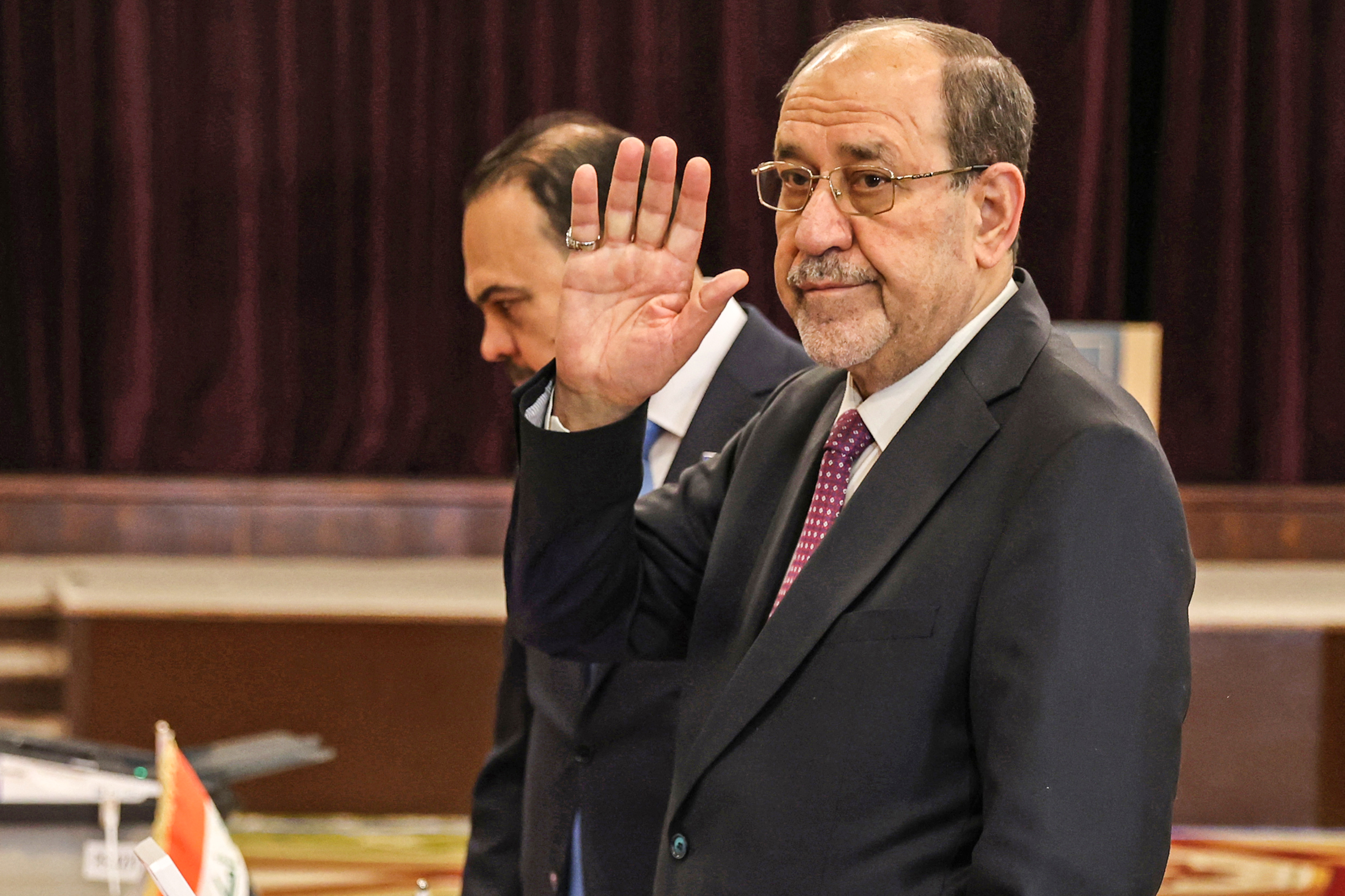 Former Iraqi prime minister Nouri al-Maliki arrives to cast his ballot at a polling station in Baghdad on November 11, 2025 during Iraq's parliamentary elections.