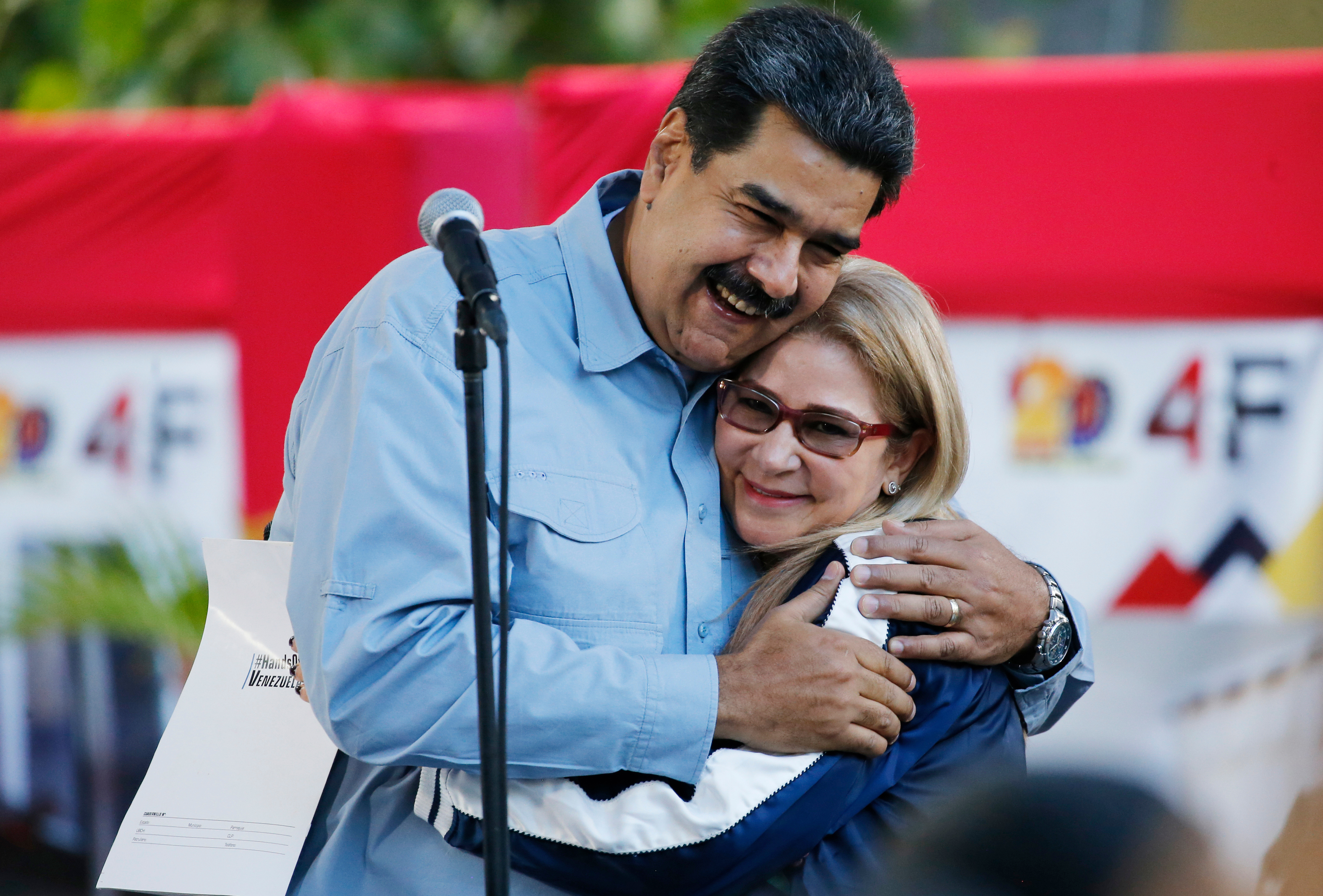 FILE - Venezuela's President Nicolas Maduro hugs first lady Cilia Flores during an event at Bolivar Square in Caracas, Venezuela, Feb. 7, 2019. (AP Photo/Ariana Cubillos, File)