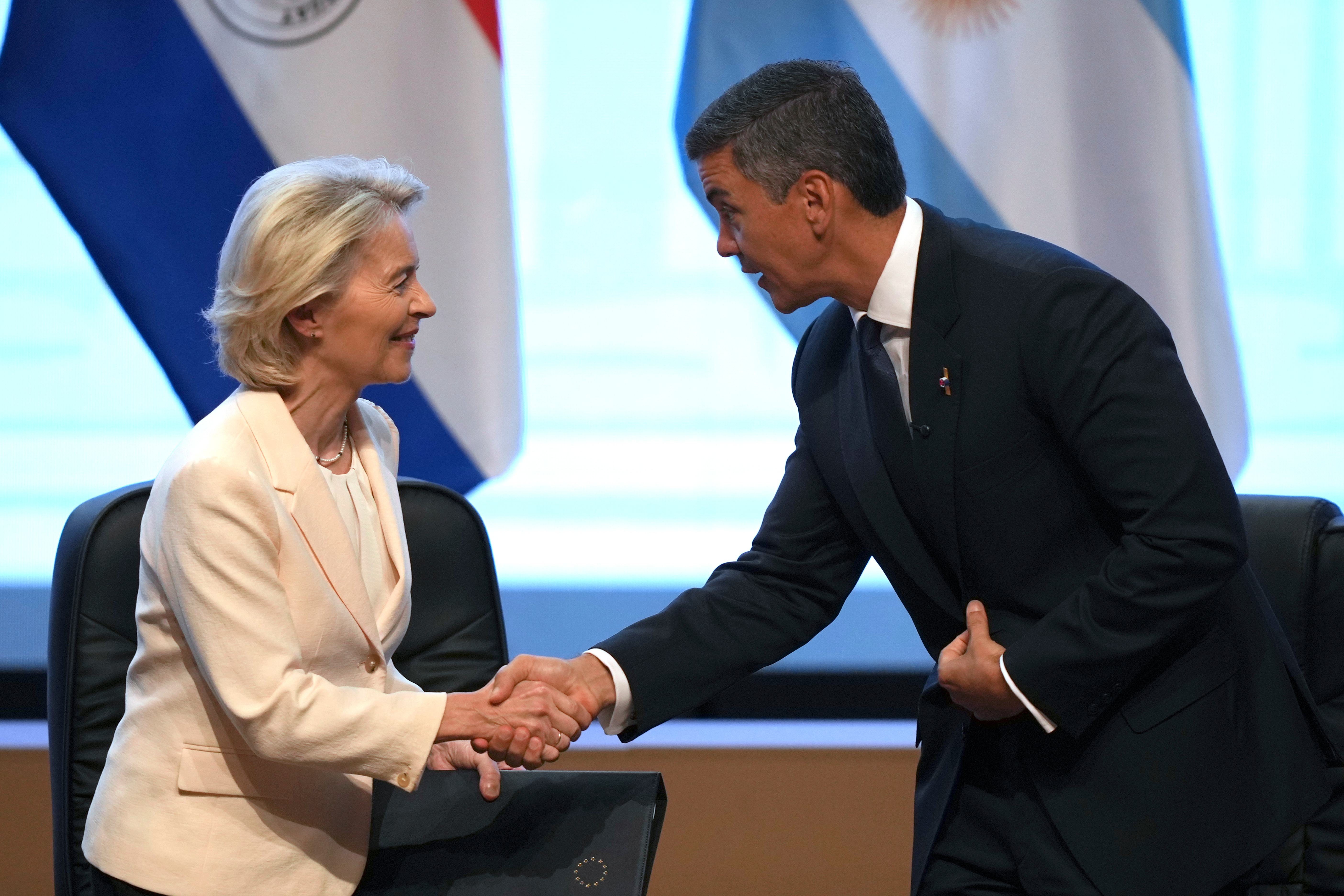 European Commission President Ursula von der Leyen, left, shakes hands with Paraguay's President Santiago Pena during a meeting to sign a free trade deal between the European Union and Mercosur, in Asuncion, Paraguay, Saturday, Jan. 17, 2026. (AP Photo/Jorge Saenz)