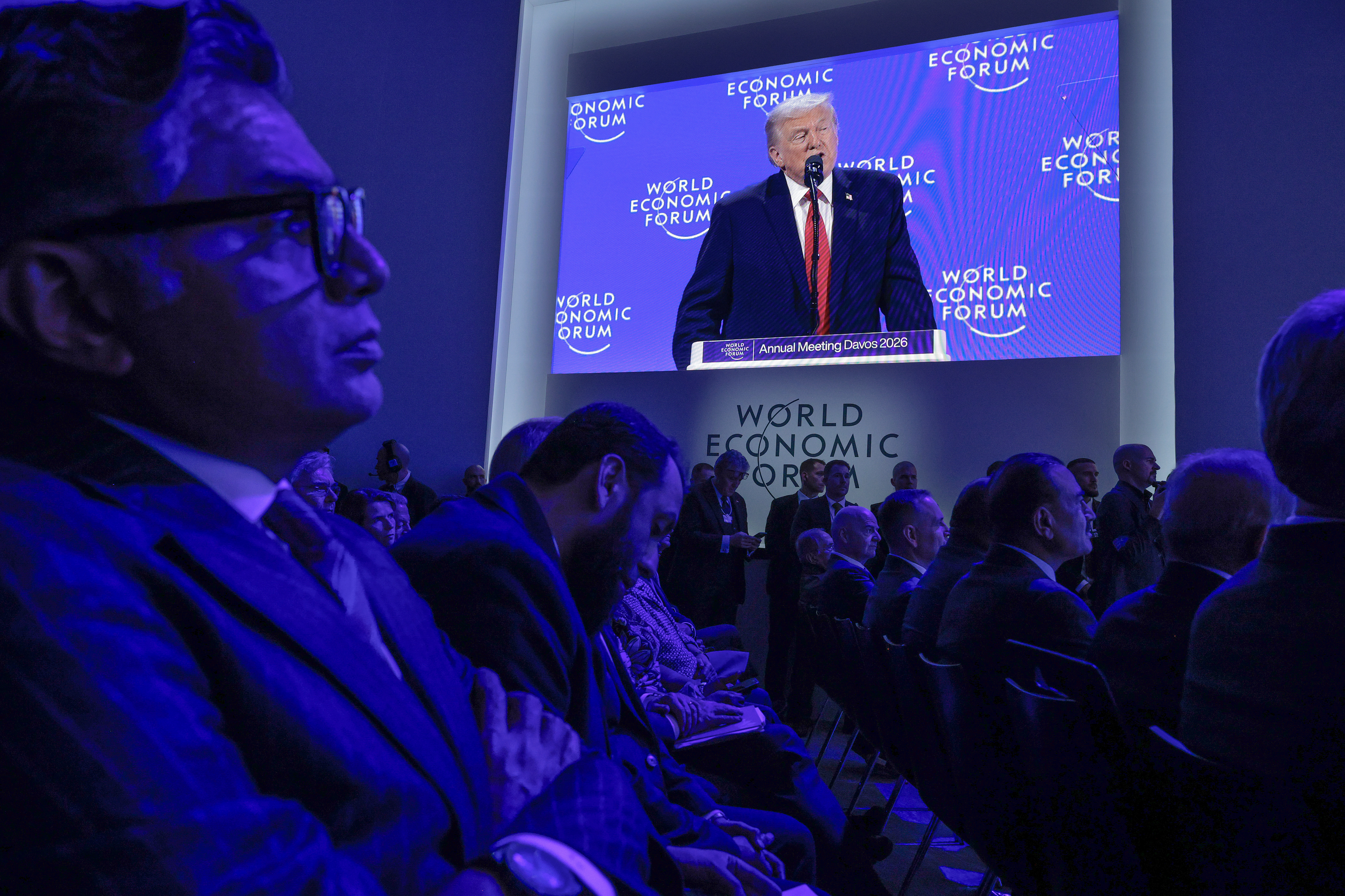 US President Donald Trump appears on a large screen as he addresses the World Economic Forum (WEF).