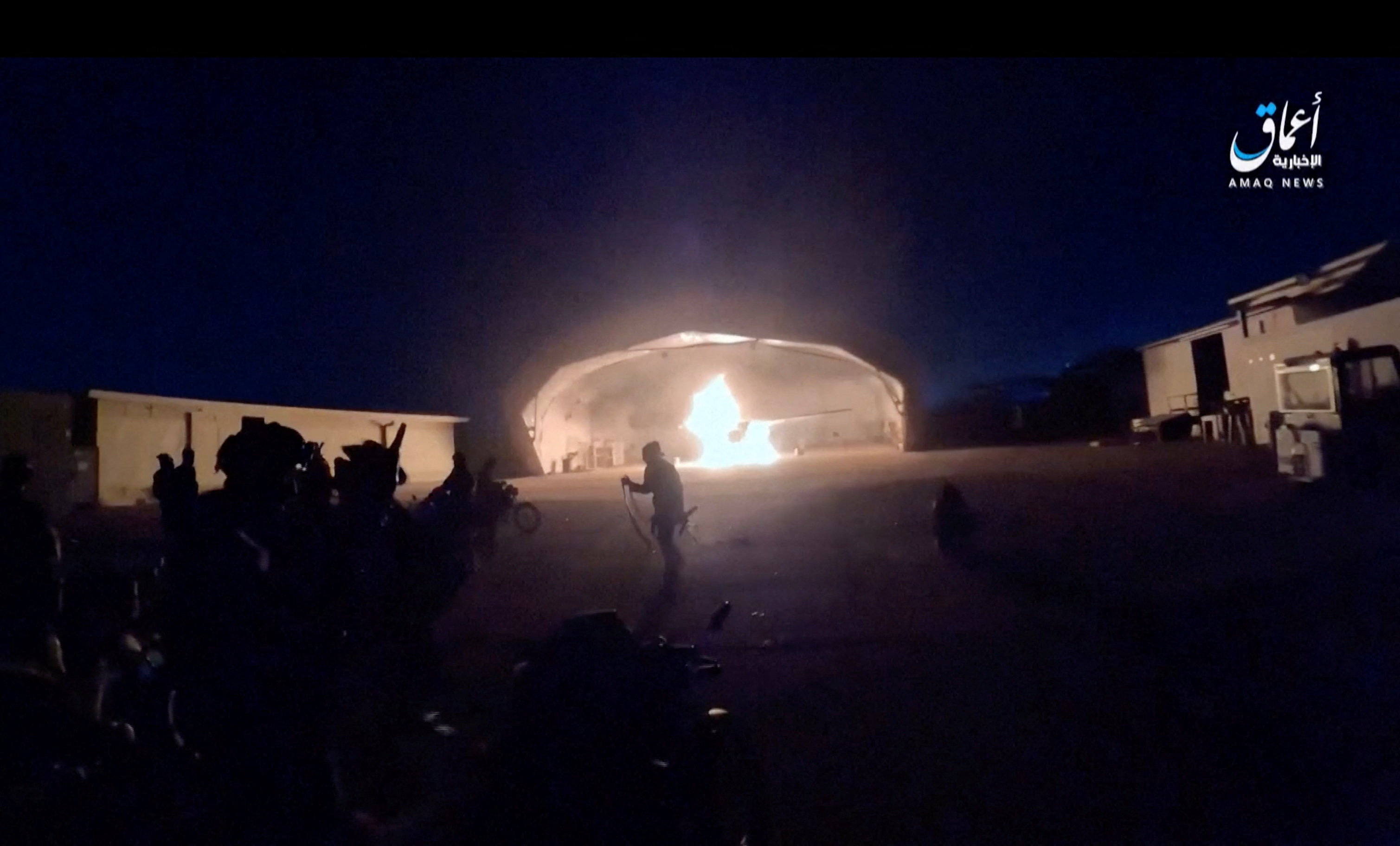 An aircraft burns in a hangar during an attack at the international airport in Niamey, Niger, in this still image obtained from a video [File: Amaq News Agency via Reuters]