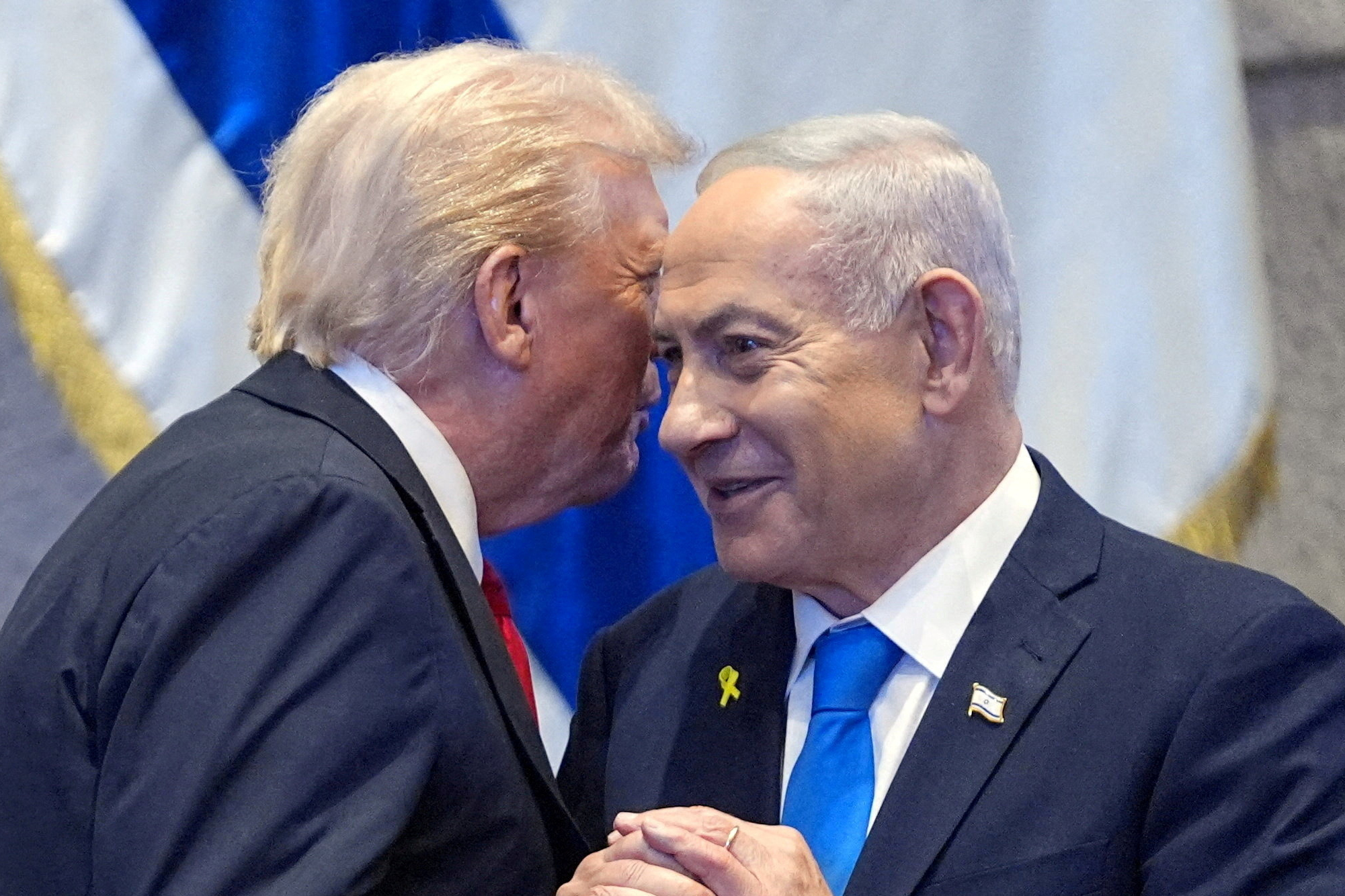 FILE PHOTO: President Donald Trump talks with Israel's Prime Minister Benjamin Netanyahu at the Knesset, Monday, Oct. 13, 2025, in Jerusalem. Evan Vucci/Pool via REUTERS/File Photo