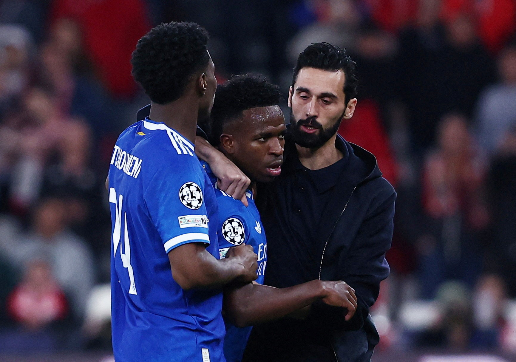 Real Madrid's Vinicius Junior with coach Alvaro Arbeloa and Aurelien Tchouameni as the match was stopped due to racist chants