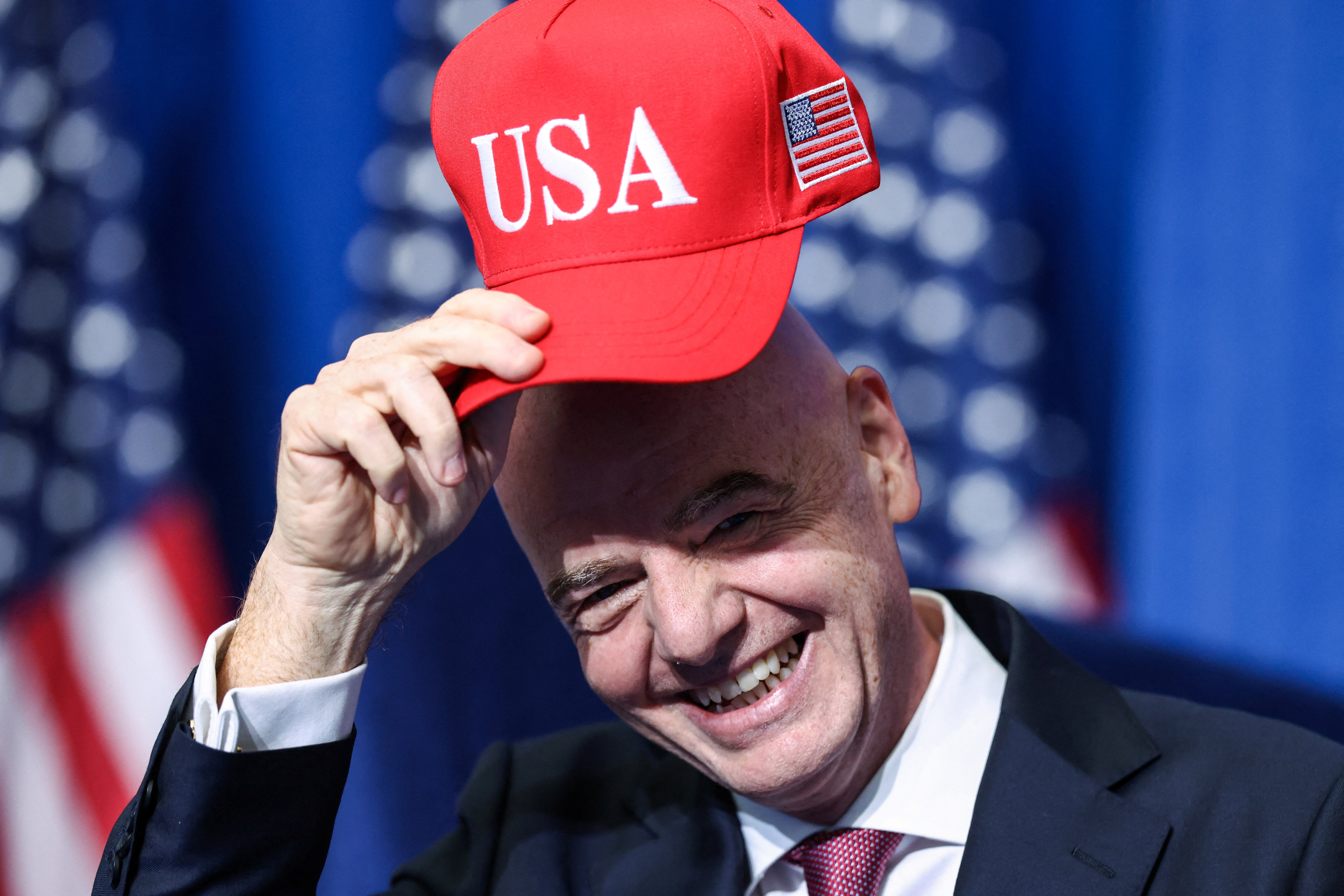 FIFA president Gianni Infantino holds a USA hat as he attends the inaugural Board of Peace meeting at the U.S. Institute of Peace in Washington, D.C., U.S., February 19, 2026. REUTERS/Kevin Lamarque