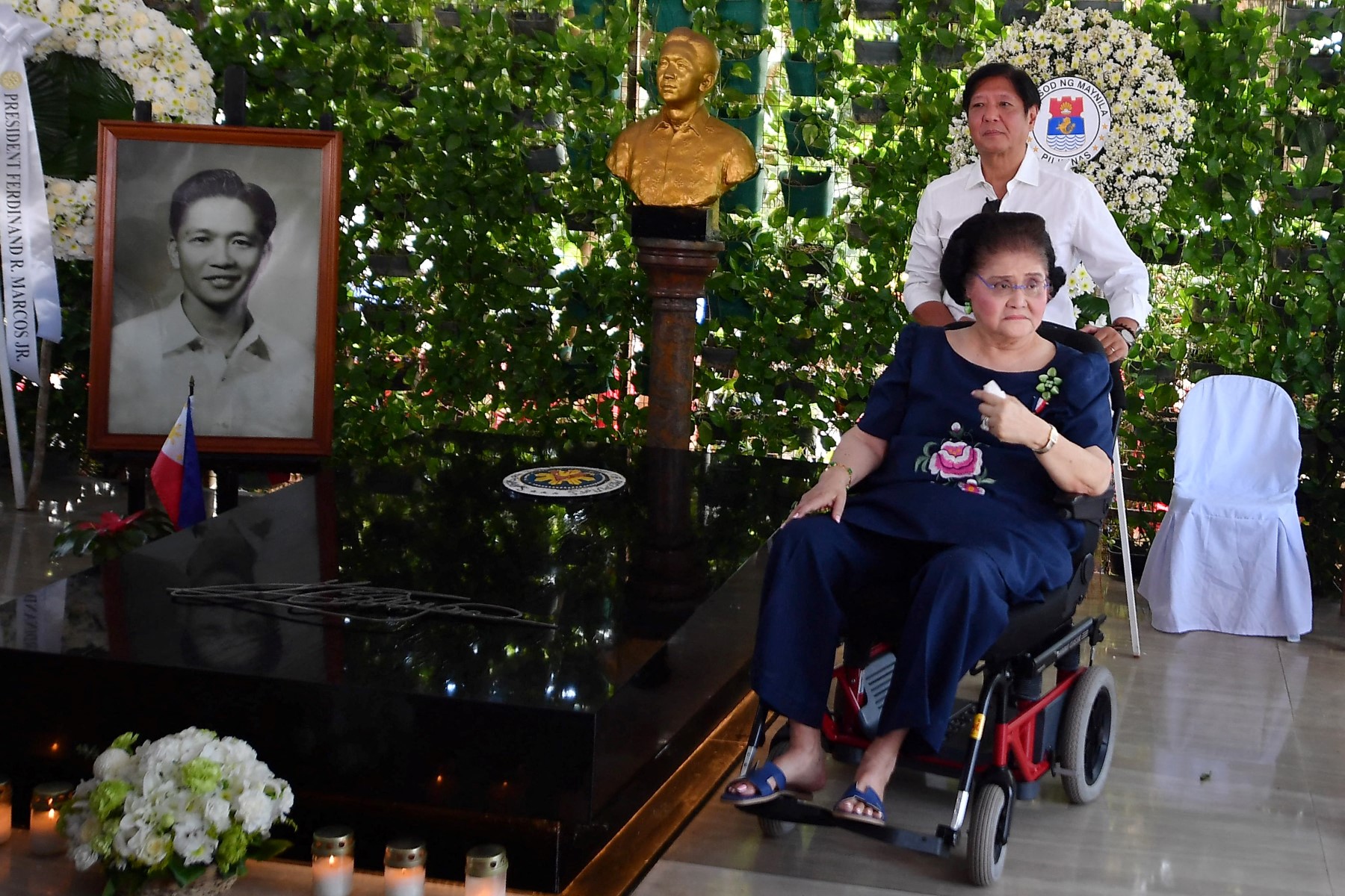 Philippine President Ferdinand Marcos (top R) stands with his mother, former first lady Imelda Marcos, as they visit the tomb of former president Ferdinand Marcos Sr after a mass to commemorate All Saints' Day at the Heroes Cemetery in Manila on November 1, 2024. (Photo by TED ALJIBE / AFP)
