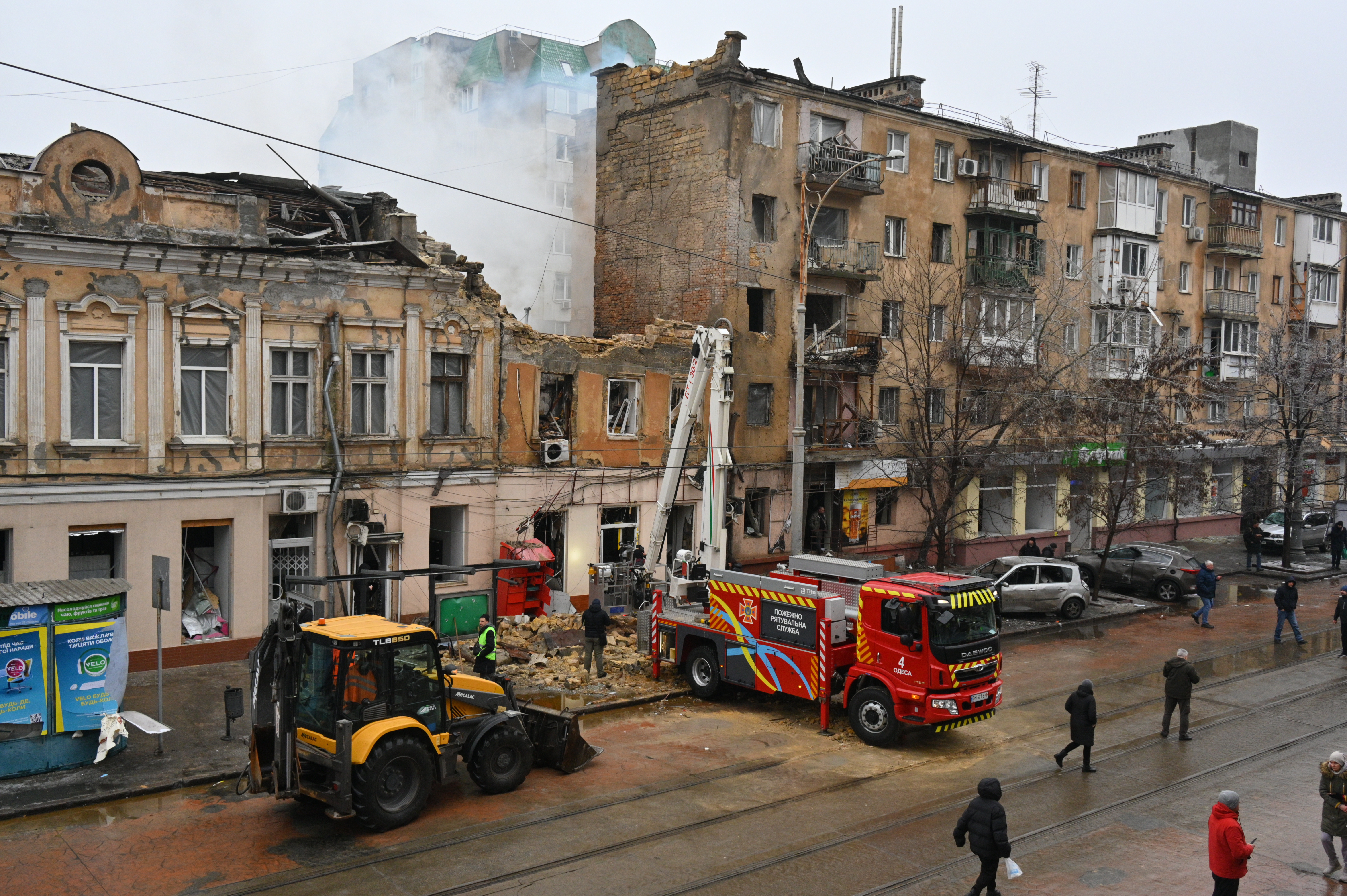 Rescue workers clear the rubble of a residential building which was heavily damaged after a Russian strike in Odesa, Ukraine