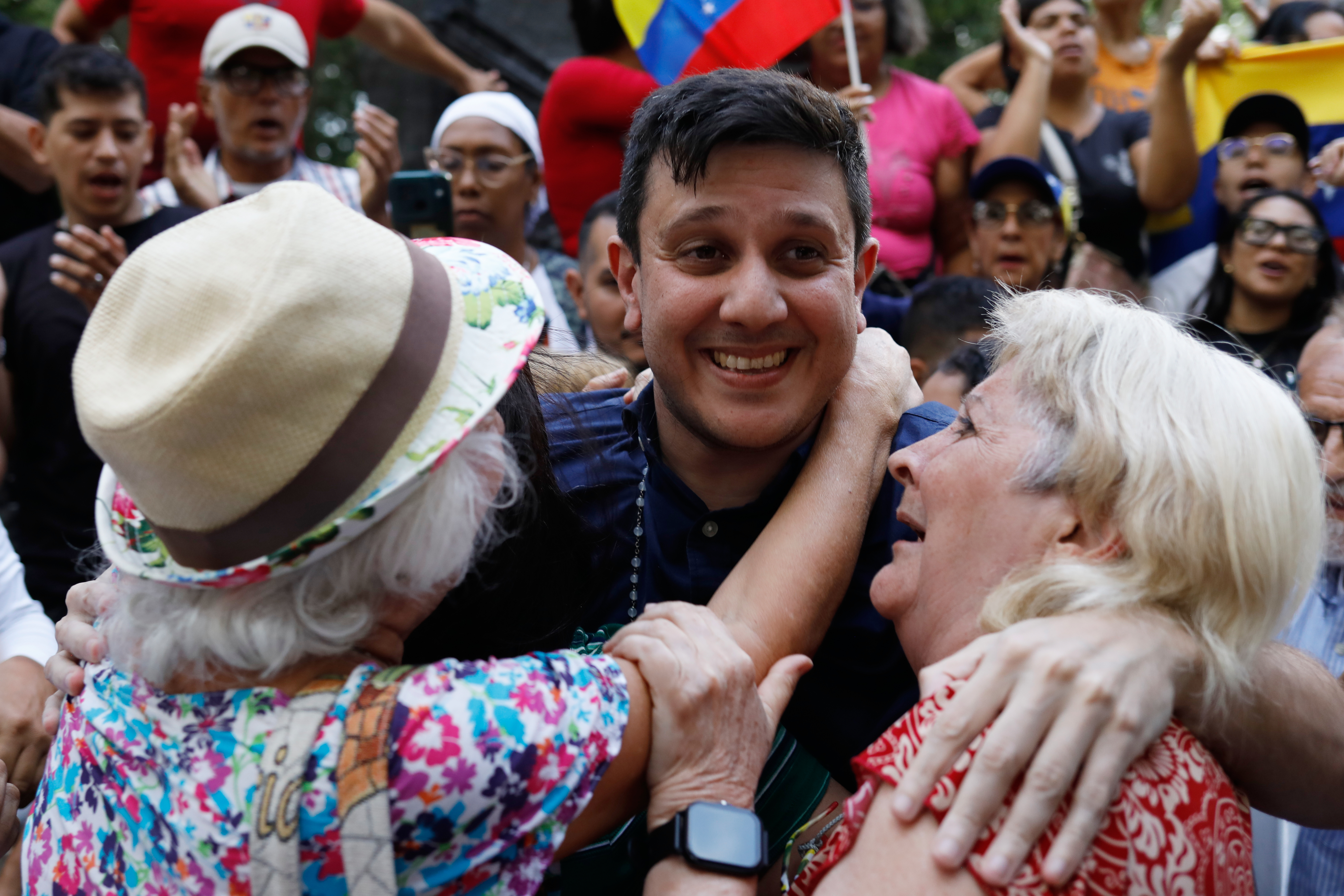 Jesus Armas participates in a parade, where he is hugged by supporters