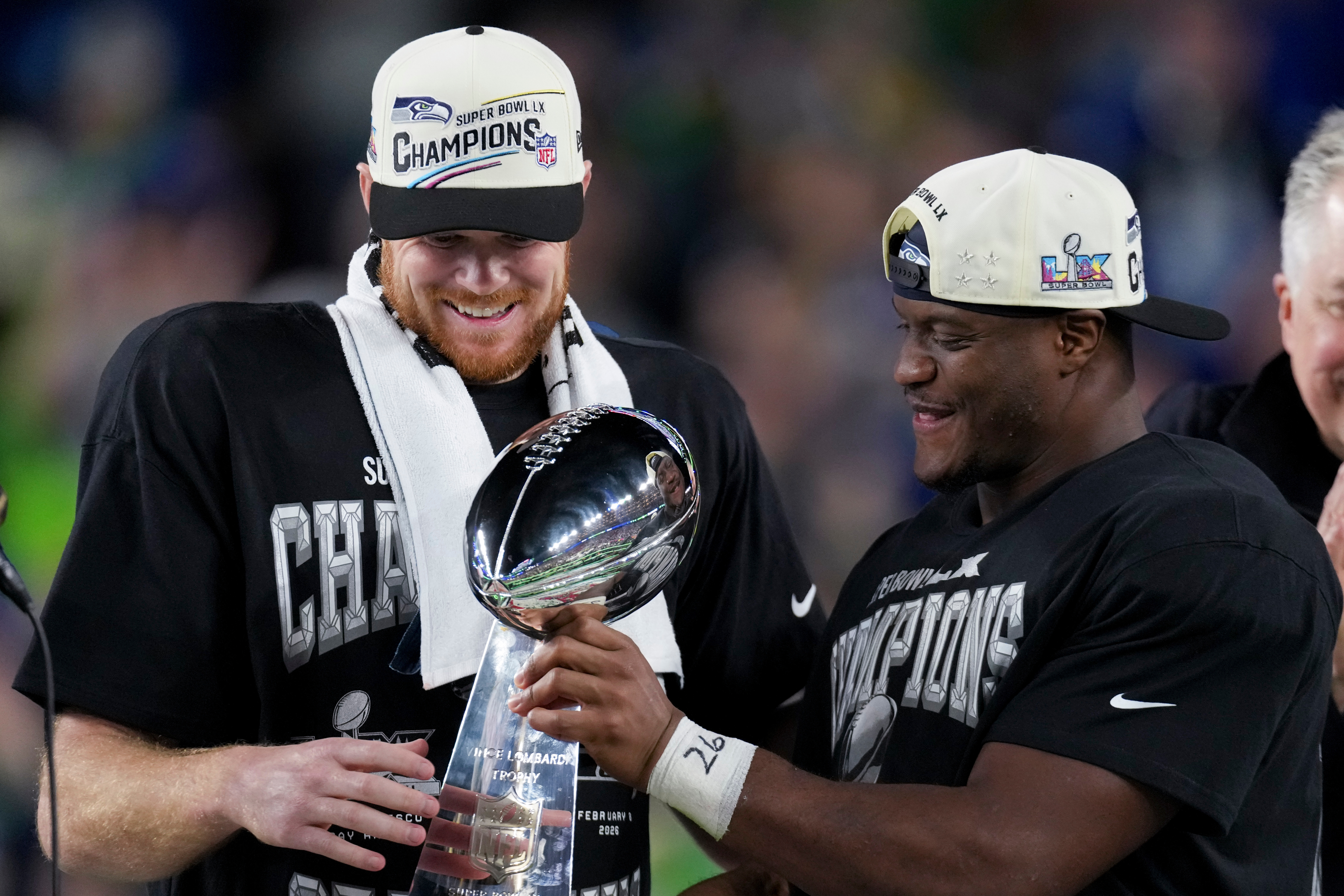 Seattle Seahawks quarterback Sam Darnold, and running back Kenneth Walker III celebrate with the Lombardi Trophy after defeating the New England Patriots after the NFL Super Bowl 60 football game, Sunday, Feb. 8, 2026, in Santa Clara, Calif. (AP Photo/Morry Gash)