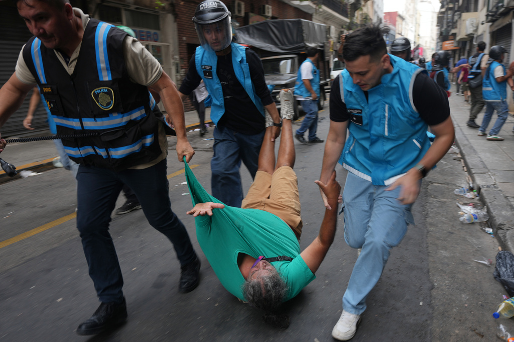 Police drag away a protester