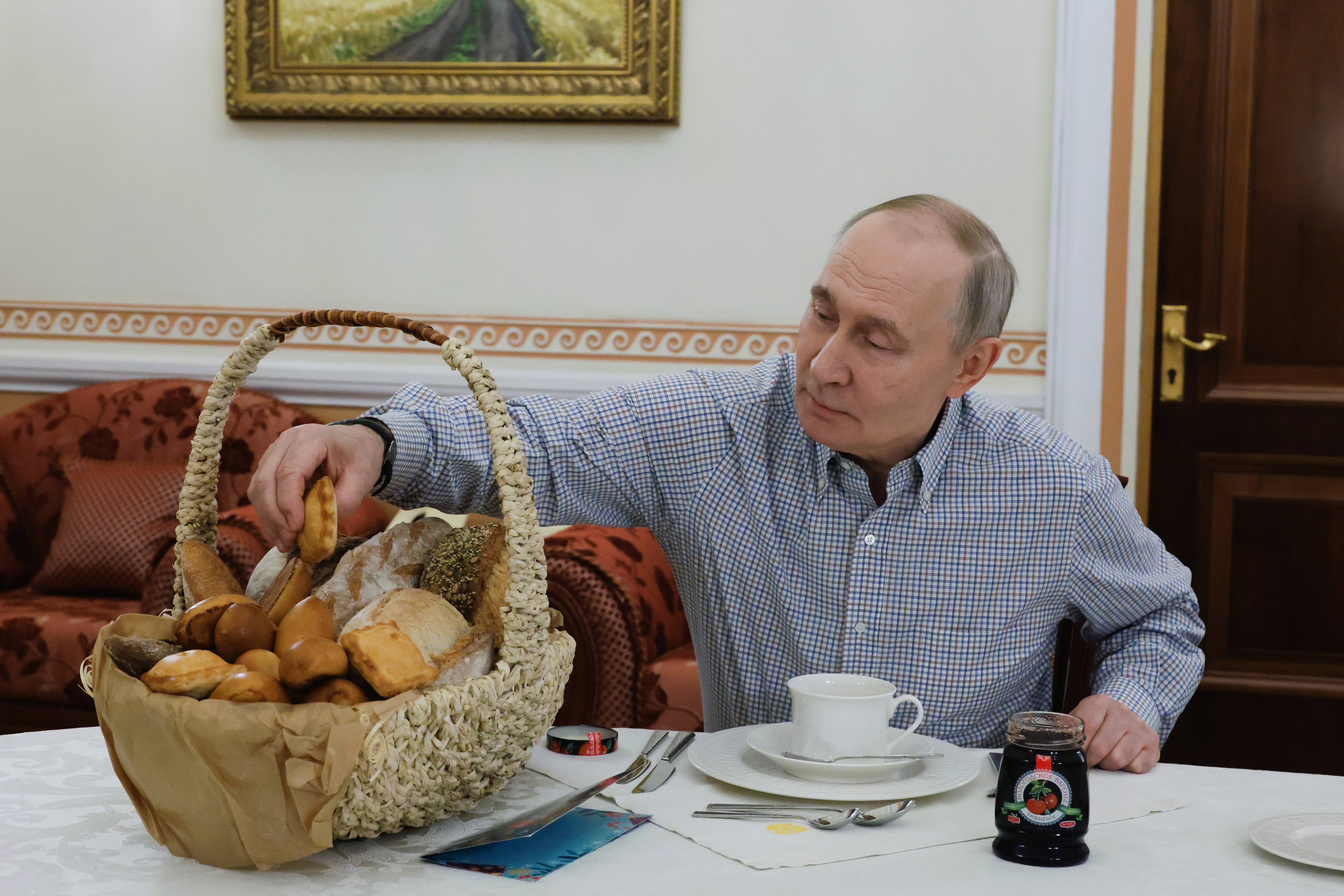 FILE - Russian President Vladimir Putin tries pastries from the Mashenka bakery in Moscow on Dec. 20, 2025, after the owner asked him about tax reforms at his annual call-in show. (Mikhail Metzel, Sputnik, Kremlin Pool Photo via AP, File)