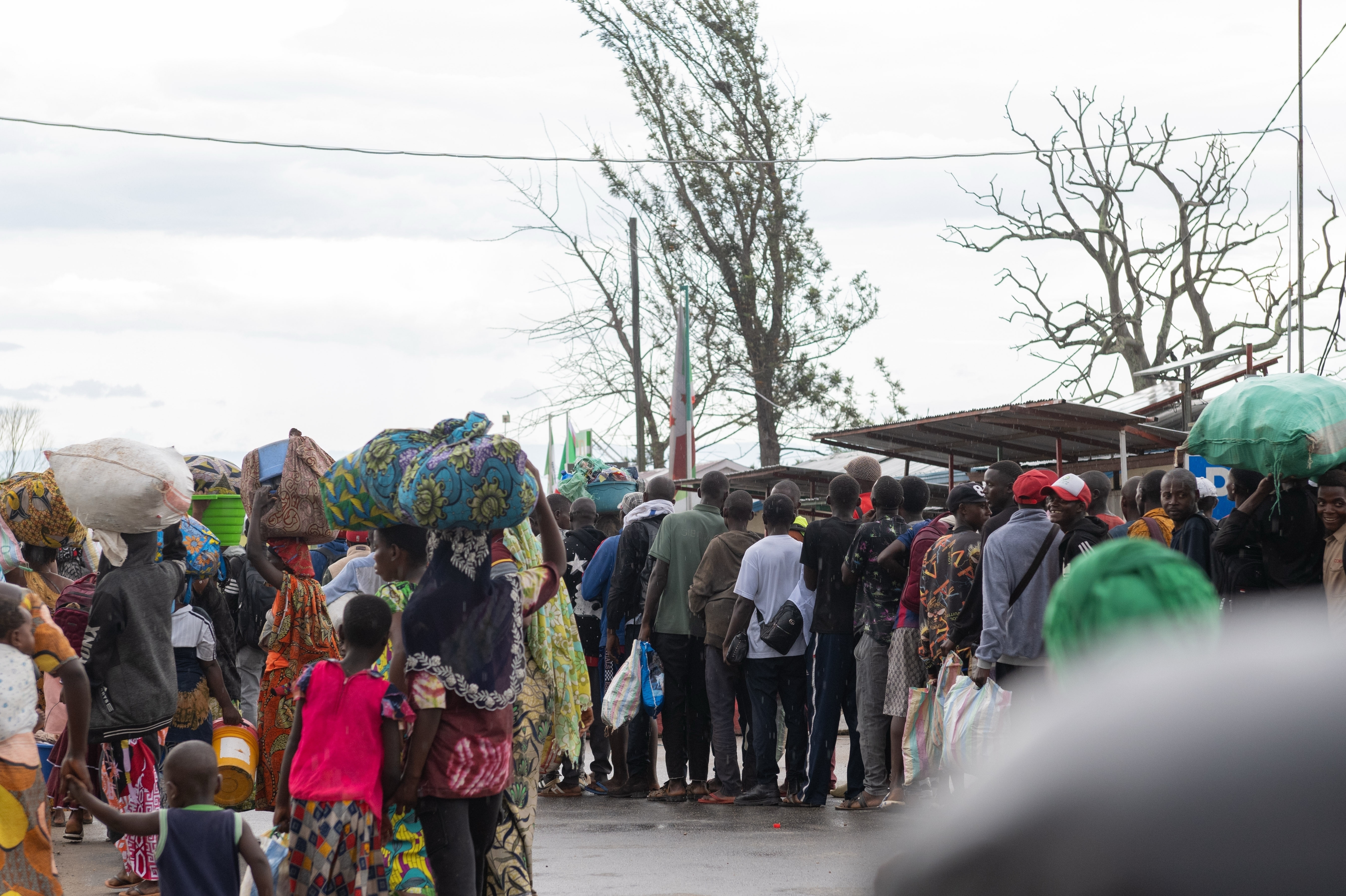 FILE - Burundian citizens who work in Uvira, Democratic Republic of the Congo, and could not cross back into their home country due to fighting, cross the border into Burundi, Dec. 14, 2025. (AP Photo/Moses Sawasawa, File)