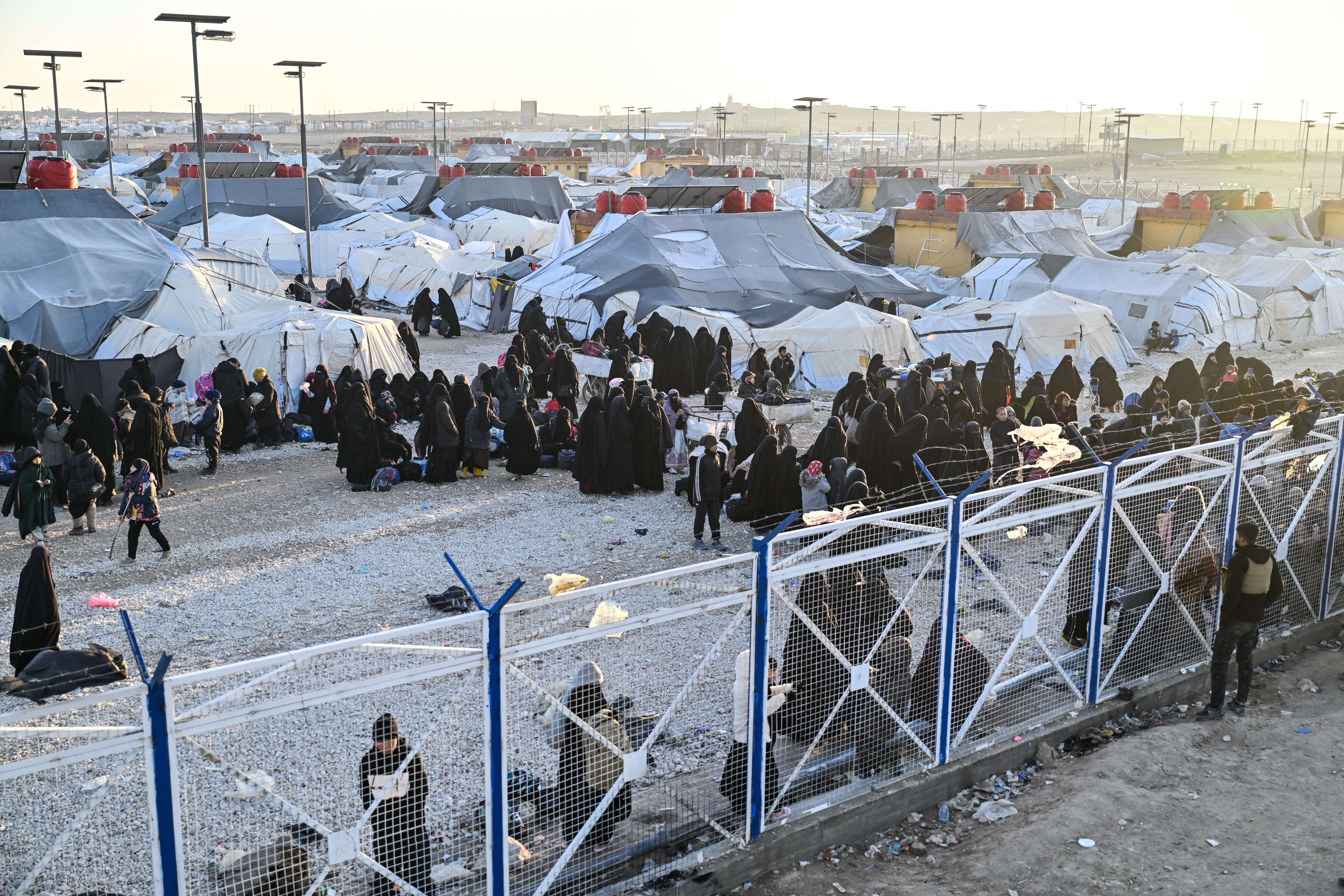AL HASAKAH, SYRIA - JANUARY 25: Women and children seen inside al-Hol camp, amongst them some 6,200 women and children from around 40 nationalities, and including relatives of suspected Islamic State jihadists in the desert region of Hasakah province on January 25, 2026 in Al Hasakah, Syria. The al-Hol camp (also spelled Al-Hawl) in Syria's northeastern Hasakah province has come under control by Syrian government forces, following the withdrawal of the Kurdish-led Syrian Democratic Forces (SDF) in recent days. The camp houses around 24,000 people, many of whom are women and children, with alleged links to the jihadist group Islamic State (IS), also referred to as ISIS in the region. Clashes between the SDF and government forces this month over the former's integration with state institutions has seen large swaths of Kurdish-controlled territory ceded. Under a ceasefire agreement, camps and prisons housing ISIS detainees previously held by the US-backed Kurdish forces are to be transferred to the government. The United Nations (UN) has said it will take over management of al-Hol, resuming the delivery of humanitarian supplies to the camp, amid dire conditions. (Photo by Abdulmonam Eassa/Getty Images)