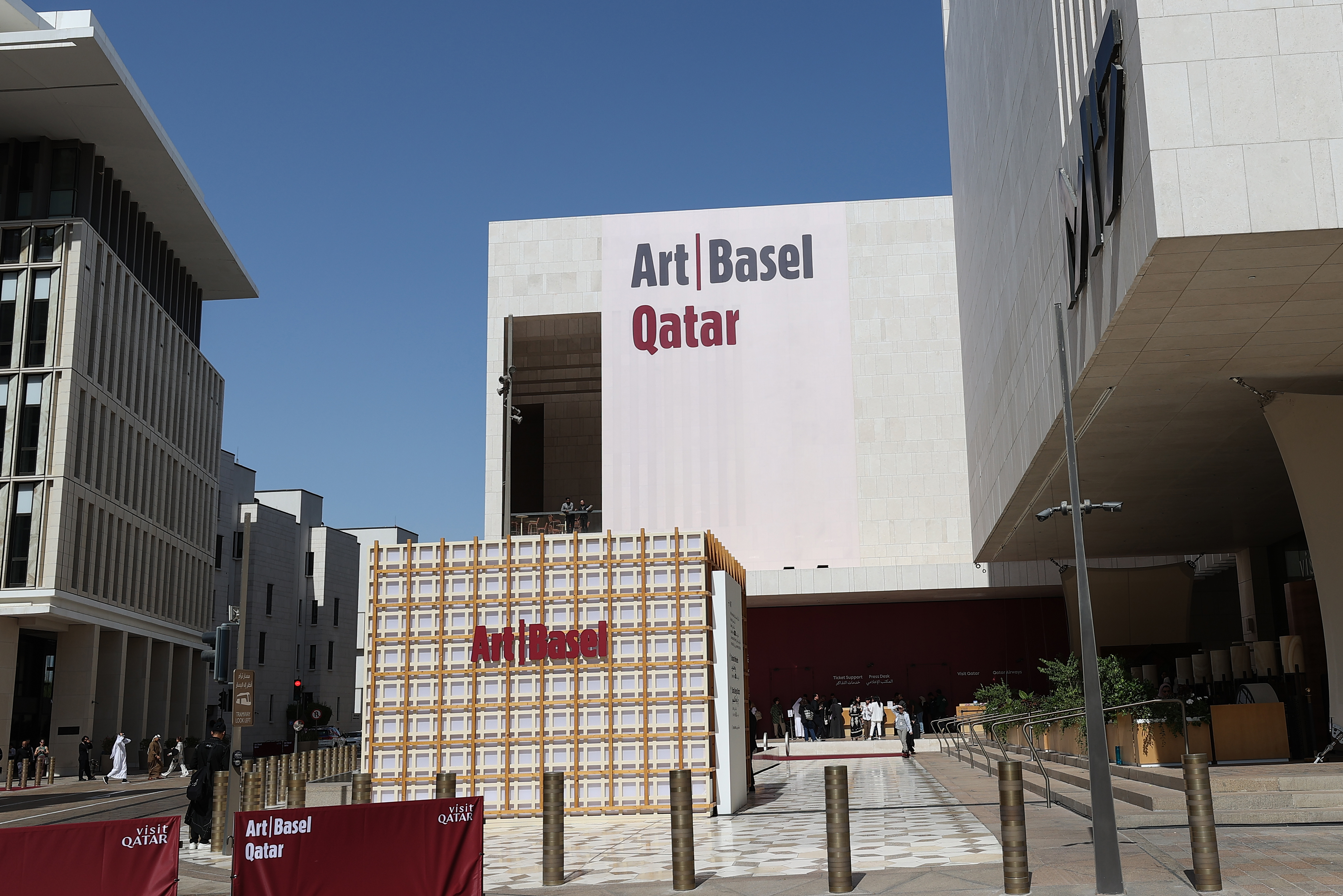Visitors explore artworks and installations at the Art Basel Qatar Edition in Doha