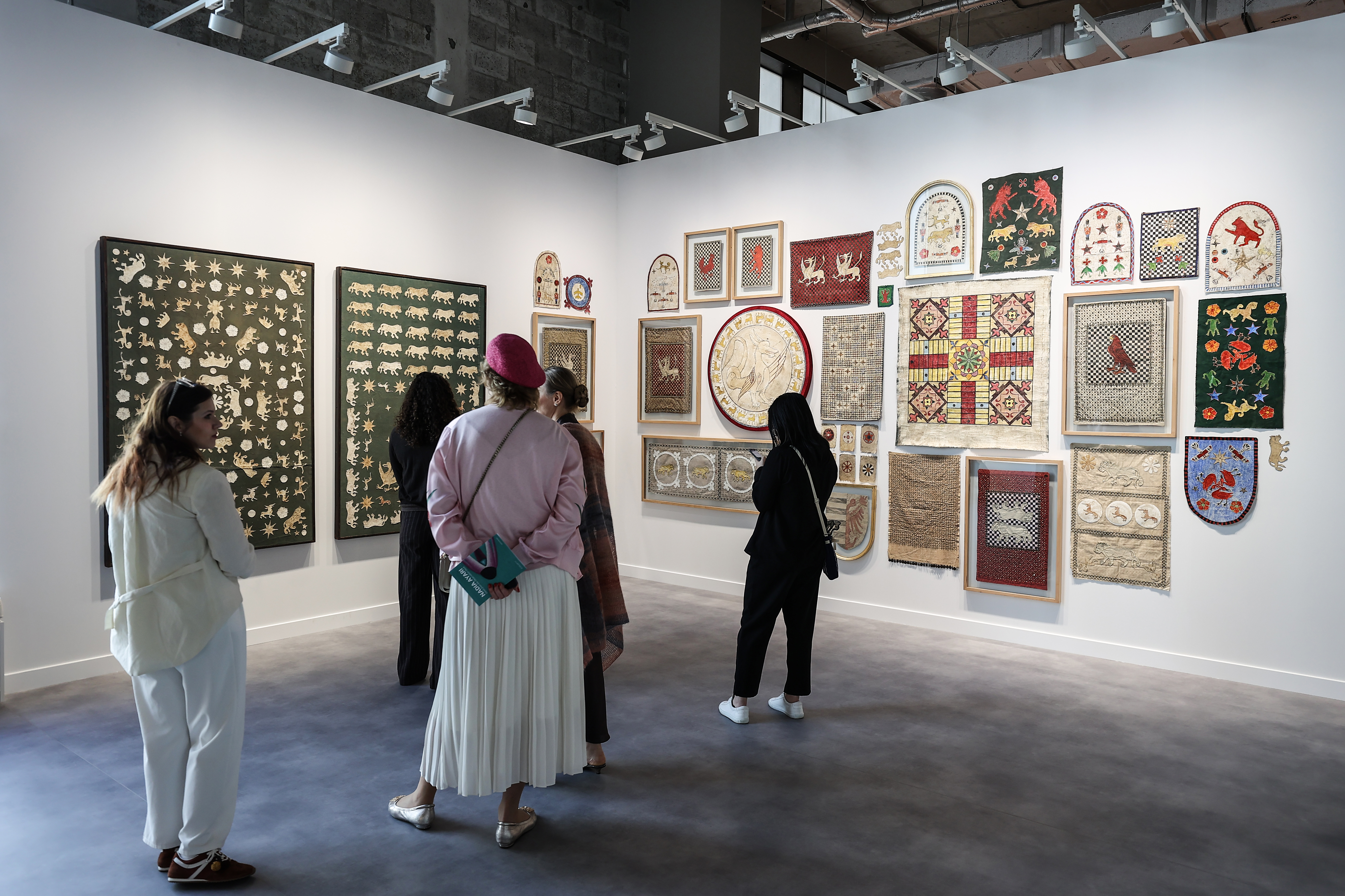 Visitors explore artworks and installations at the Art Basel Qatar Edition in Doha