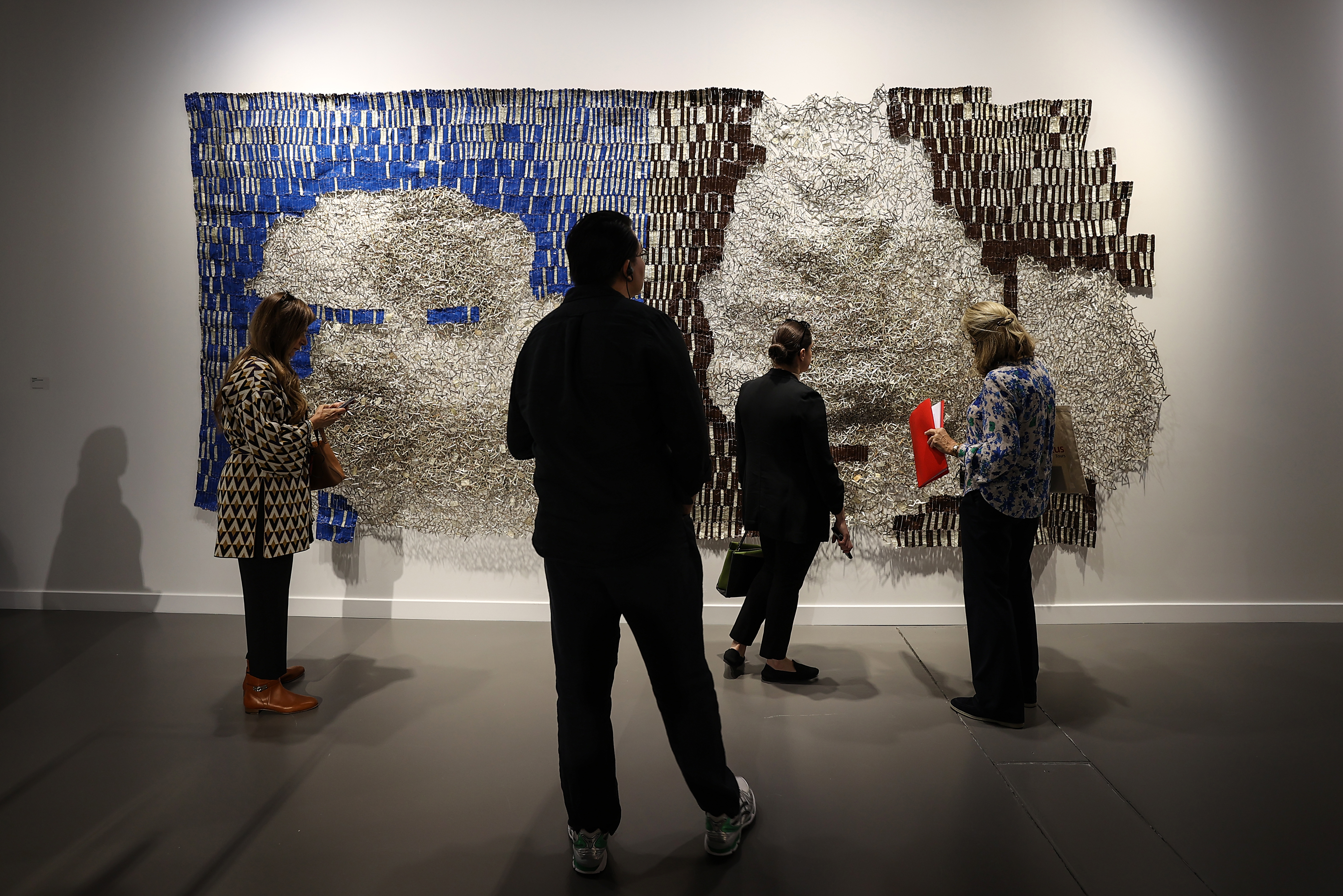 Visitors explore artworks and installations at the Art Basel Qatar Edition in Doha