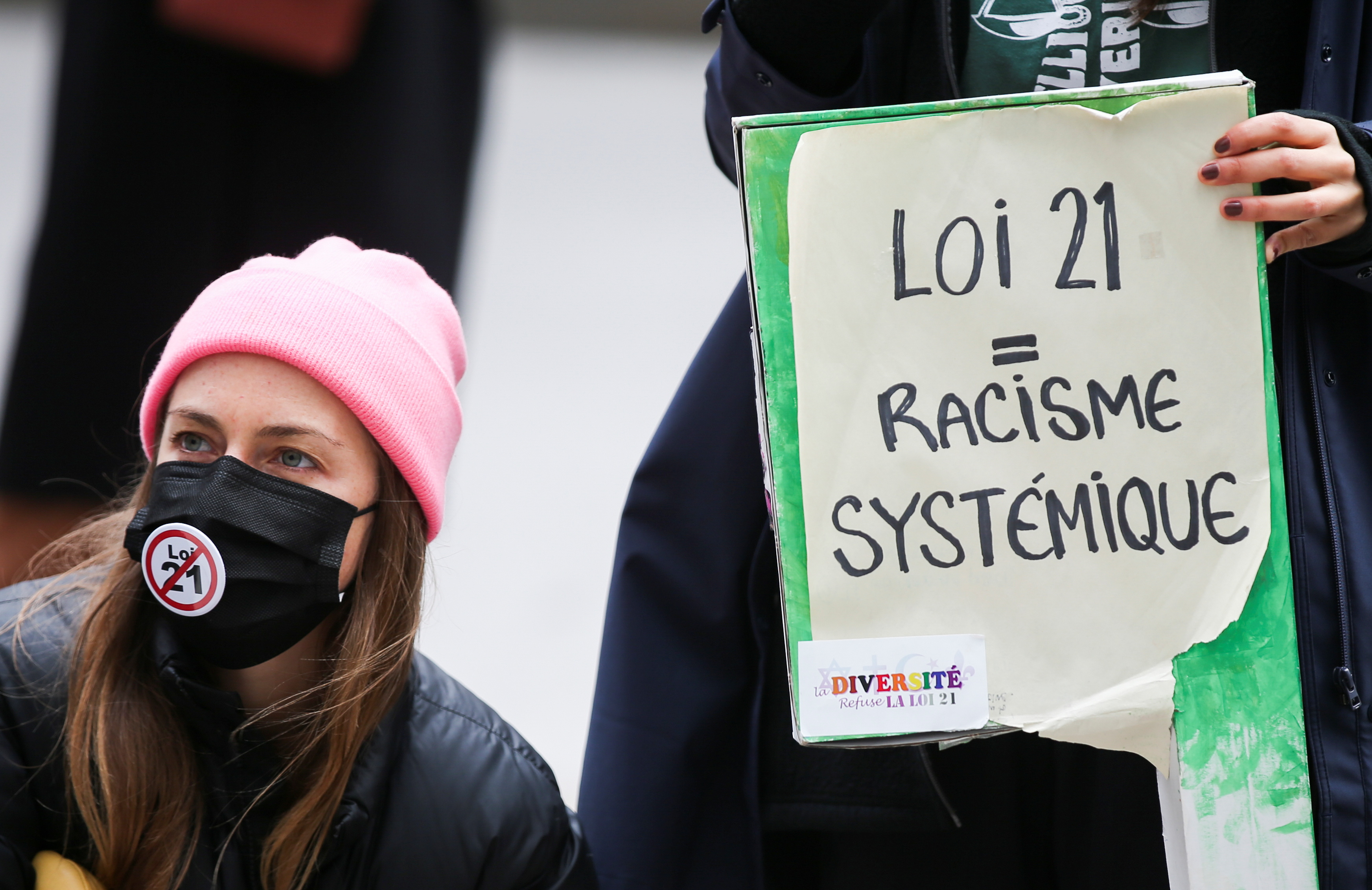 People attend a protest against Bill 21, after a court ruled that some teachers and provincial politicians are exempt from a controversial law that bans public employees from wearing religious symbols, in Montreal, Quebec, Canada April 20, 2021. REUTERS/Christinne Muschi